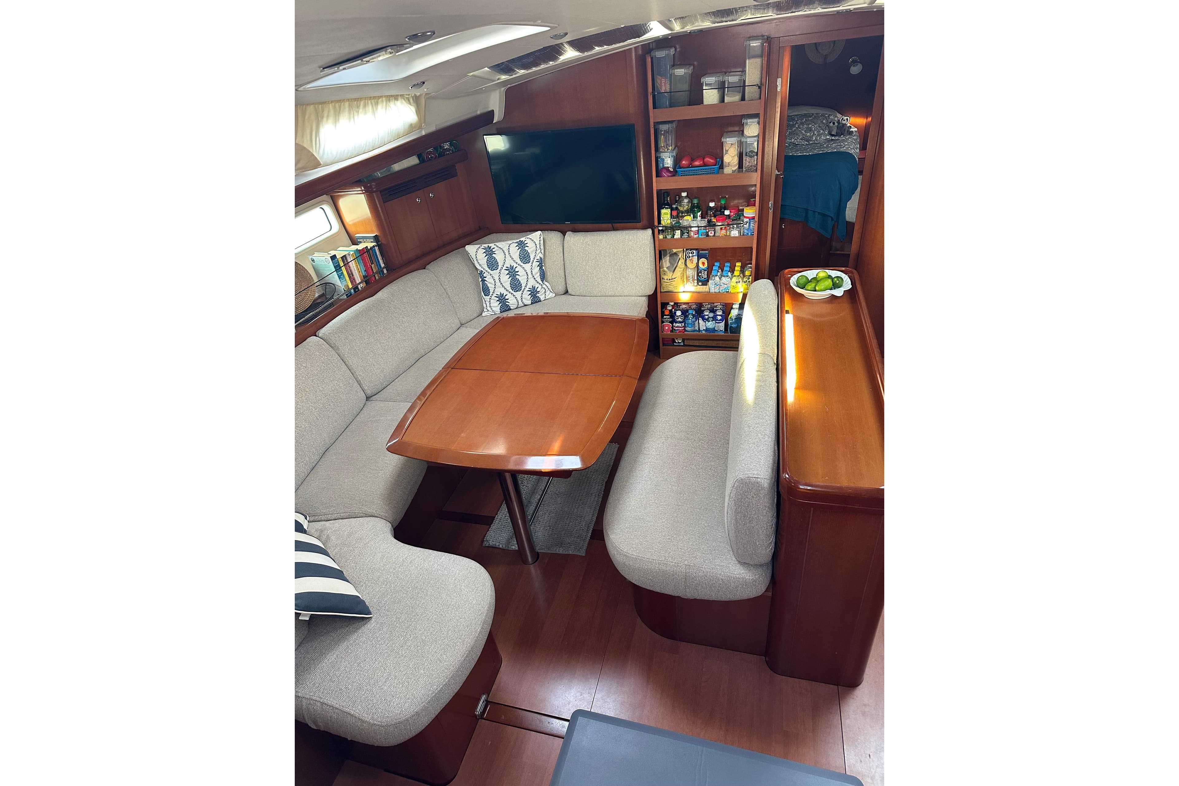 Luxurious interior of 2006 Beneteau Oceanis 523 yacht with cozy seating and elegant wood finishes.