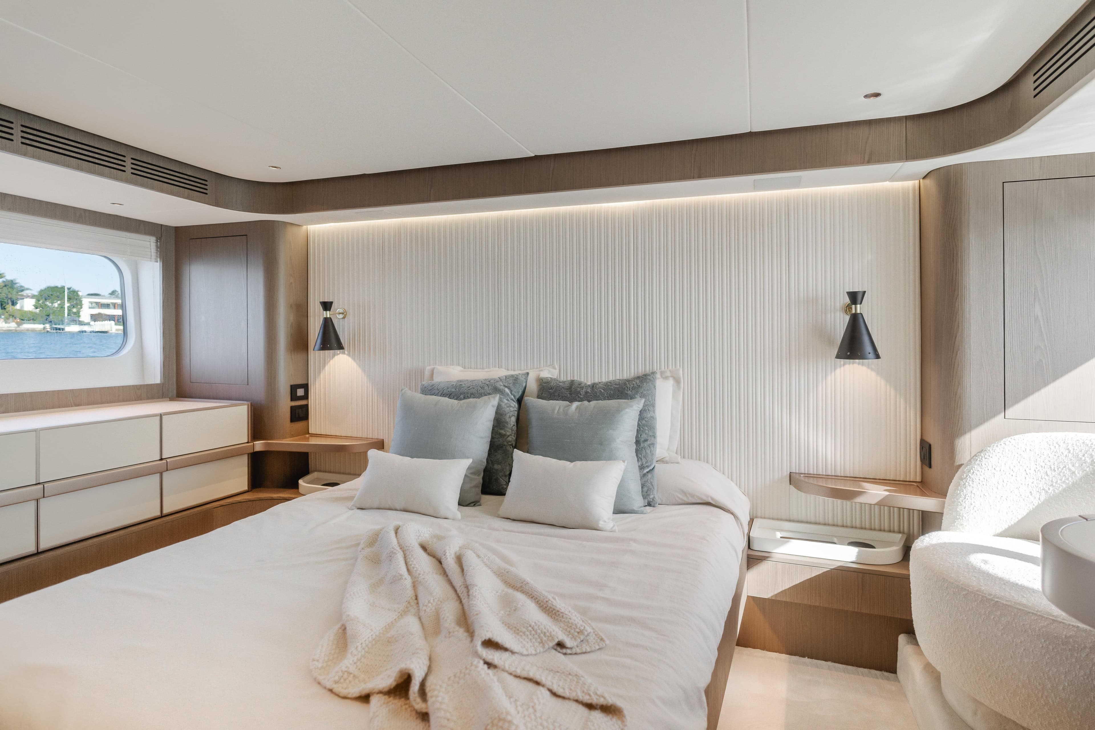 Luxurious bedroom interior of 2023 Azimut Magellano 66 yacht with modern design.