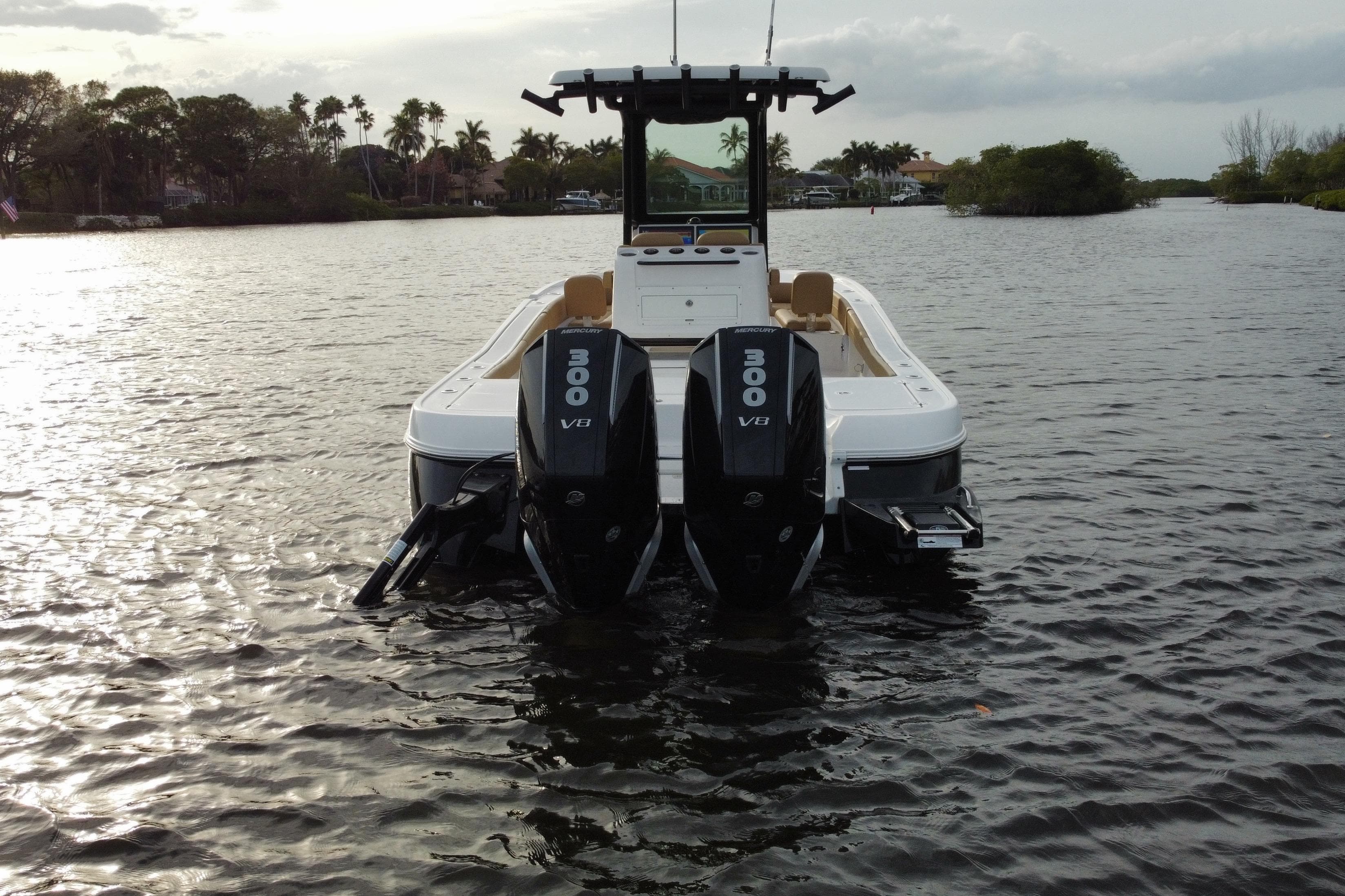 2024 Caymas 281 HB boat with dual 300 V8 engines on a calm waterway.