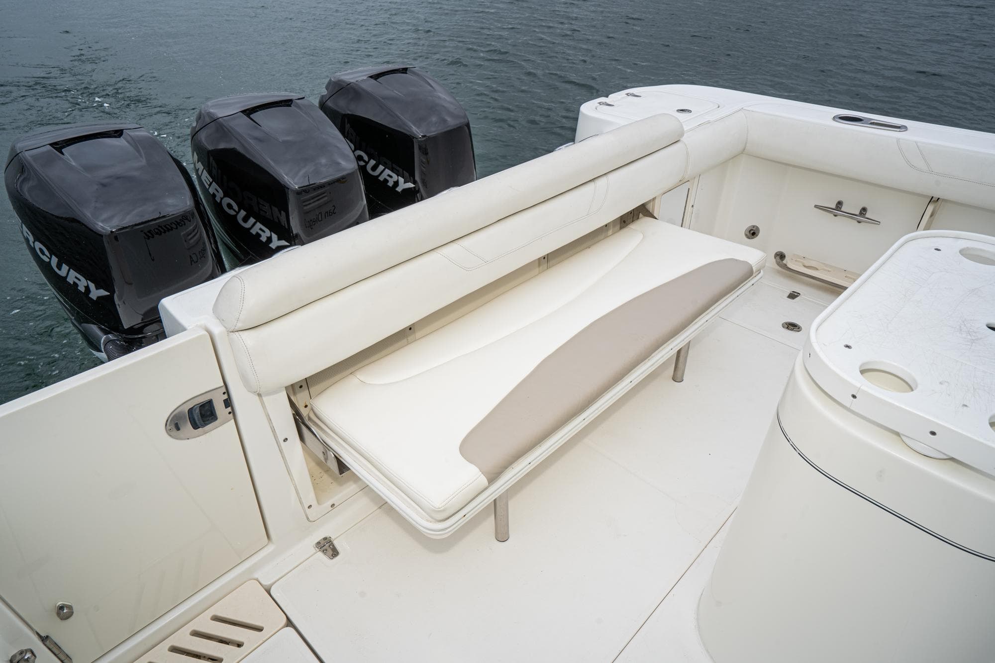 2009 Boston Whaler 345 Conquest boat with foldable seating and triple Mercury outboard engines.