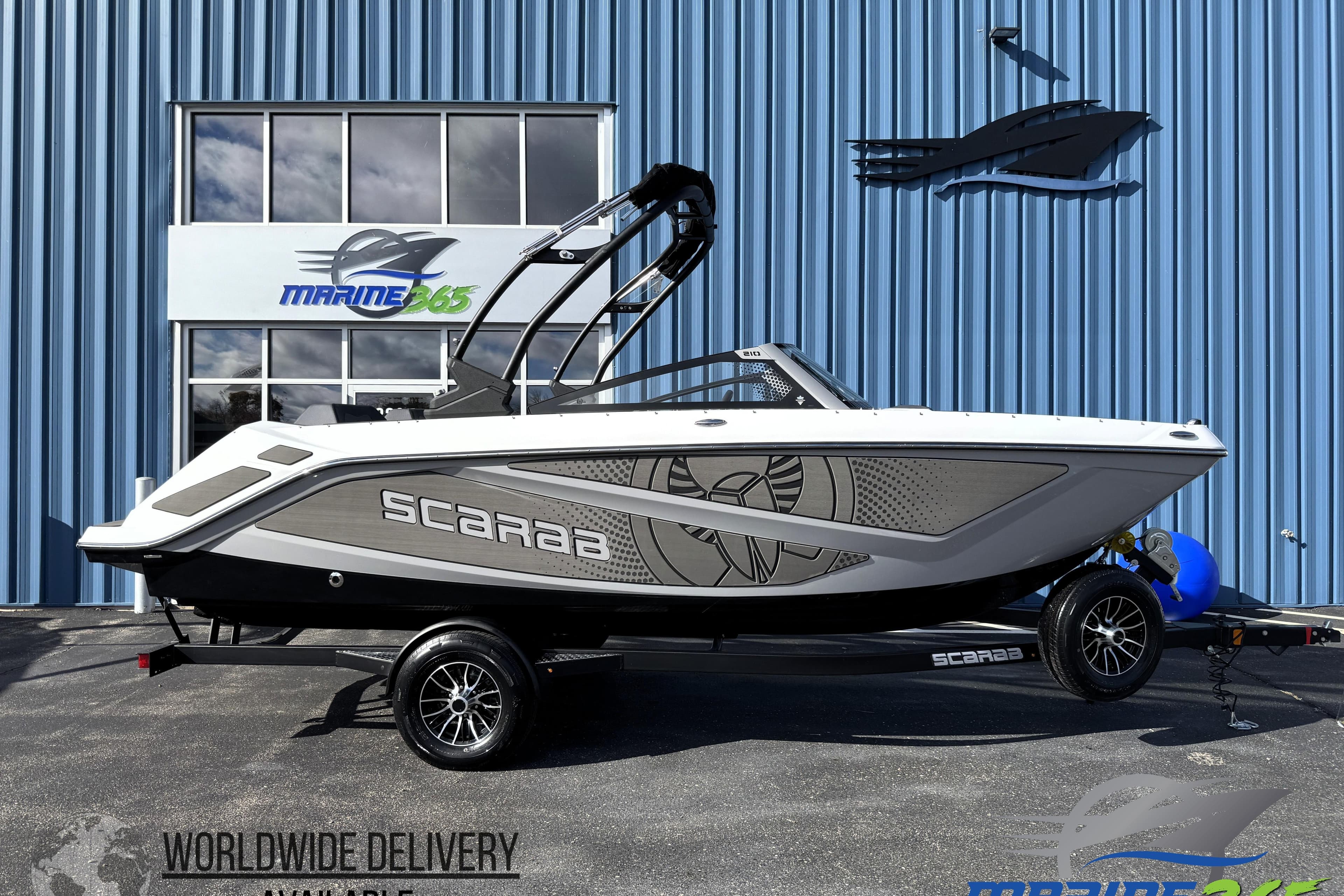 2026 Scarab 210 LX boat on trailer outside Marine365 dealership.