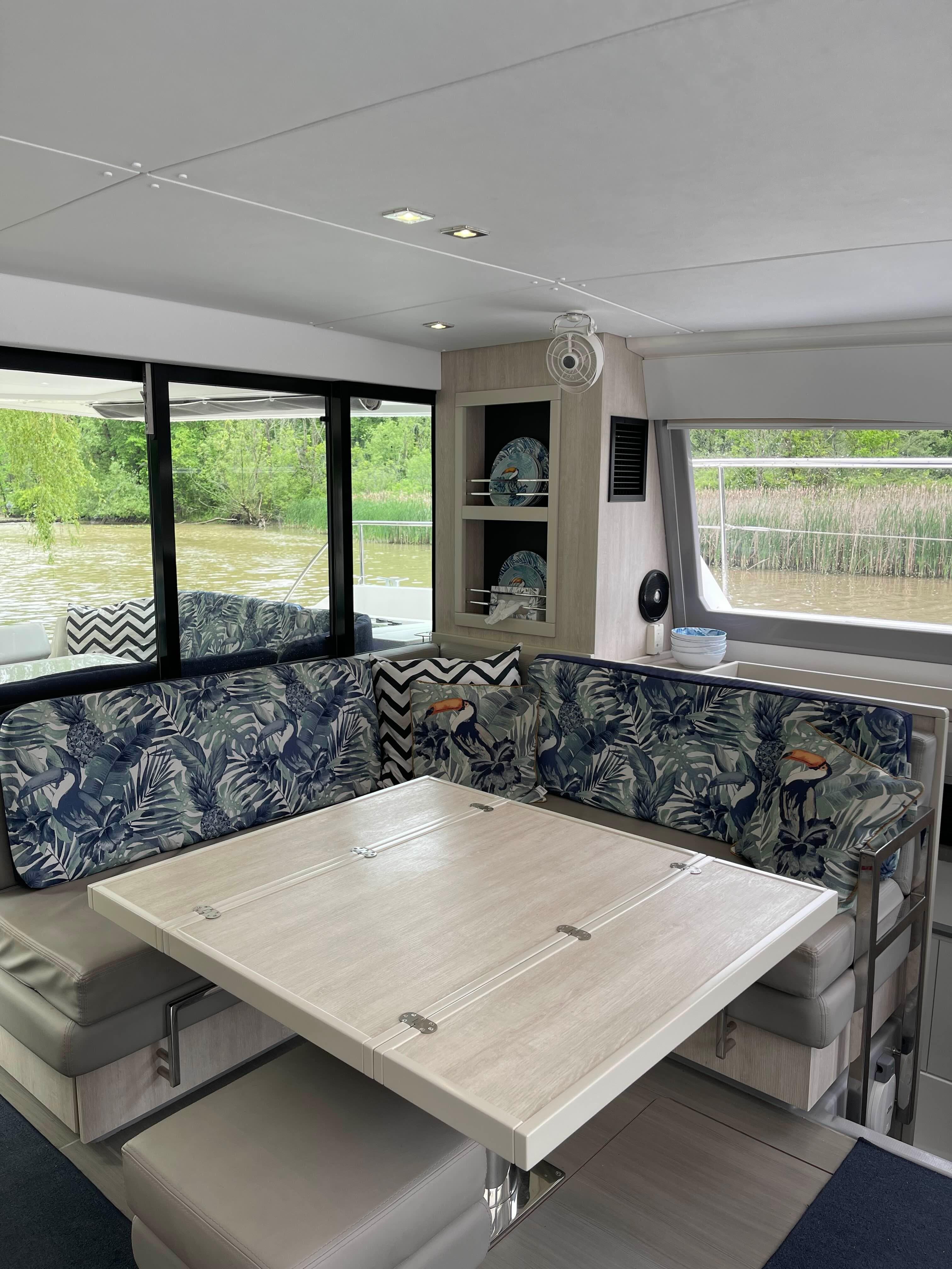 Interior of 2020 Leopard 43 Powercat with dining area and scenic window views.