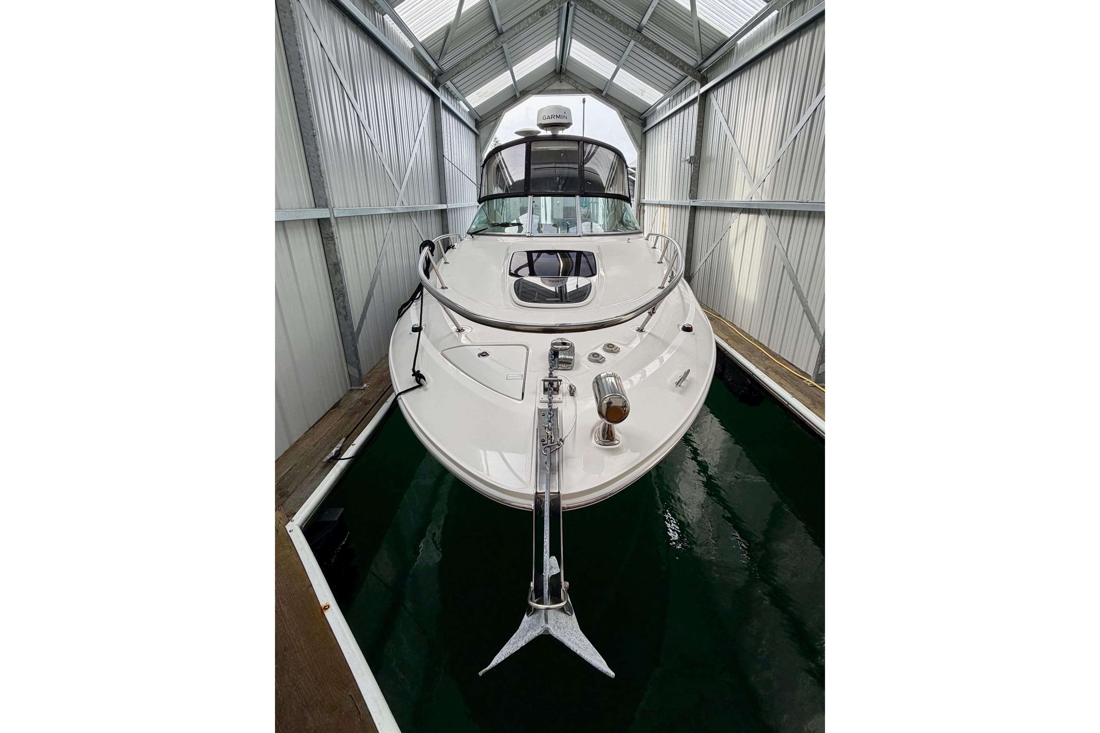 2012 Sea Ray Sundancer 280 docked in a covered marina.