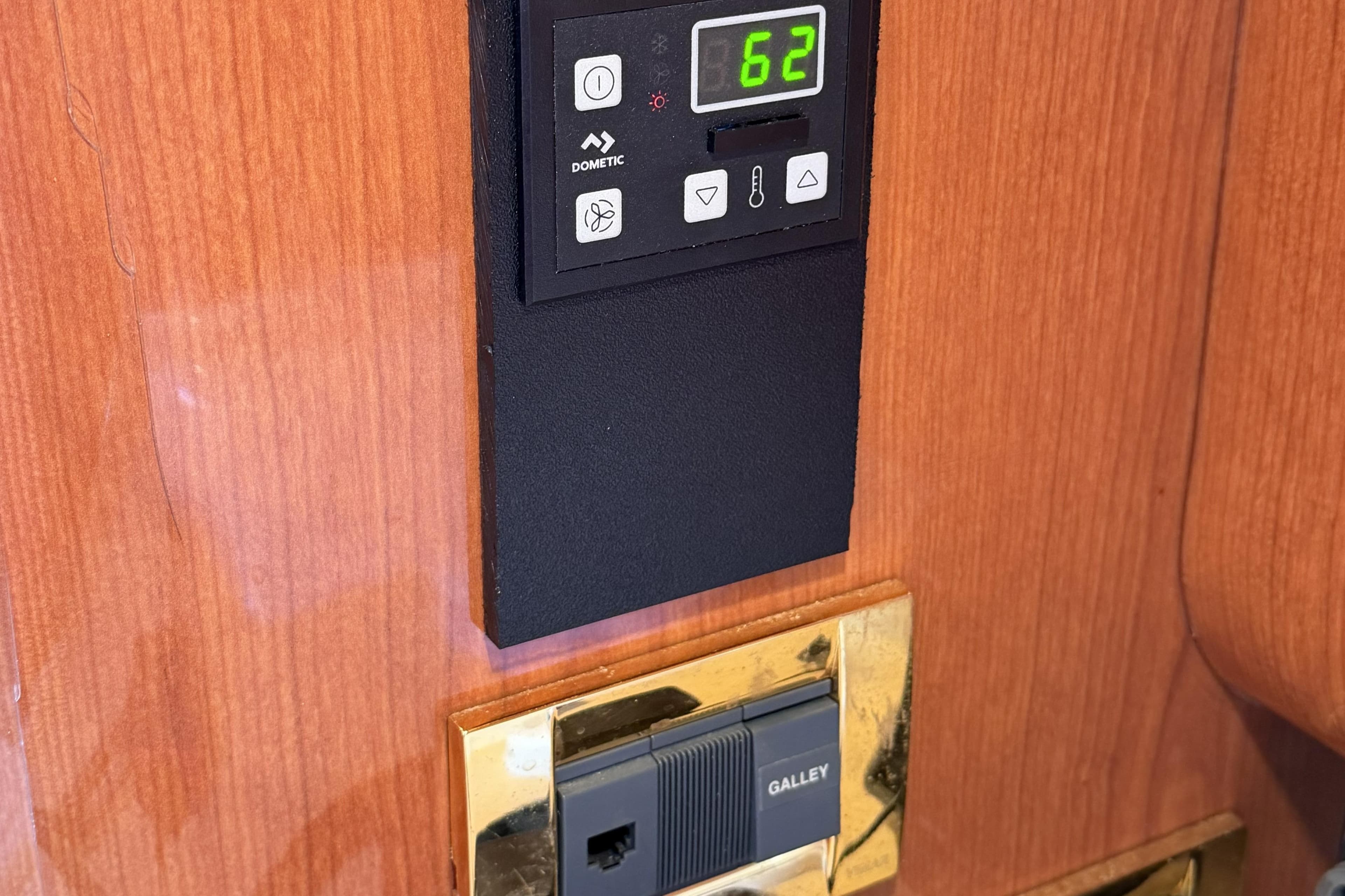 Control panel on 2000 Sea Ray 450 Express Bridge yacht interior, displaying temperature settings.