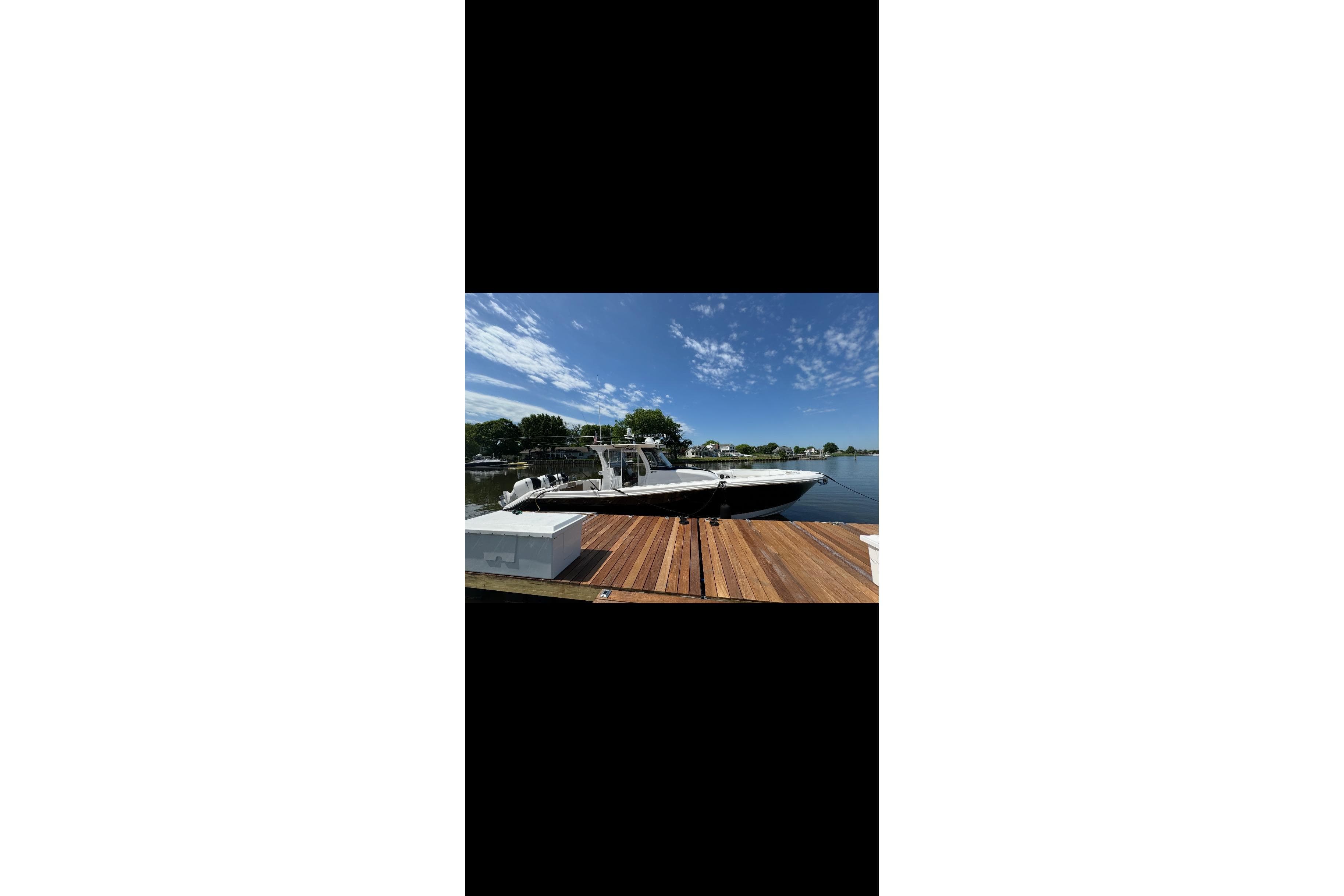2017 Edgewater 368CC boat docked on a sunny day with clear skies.