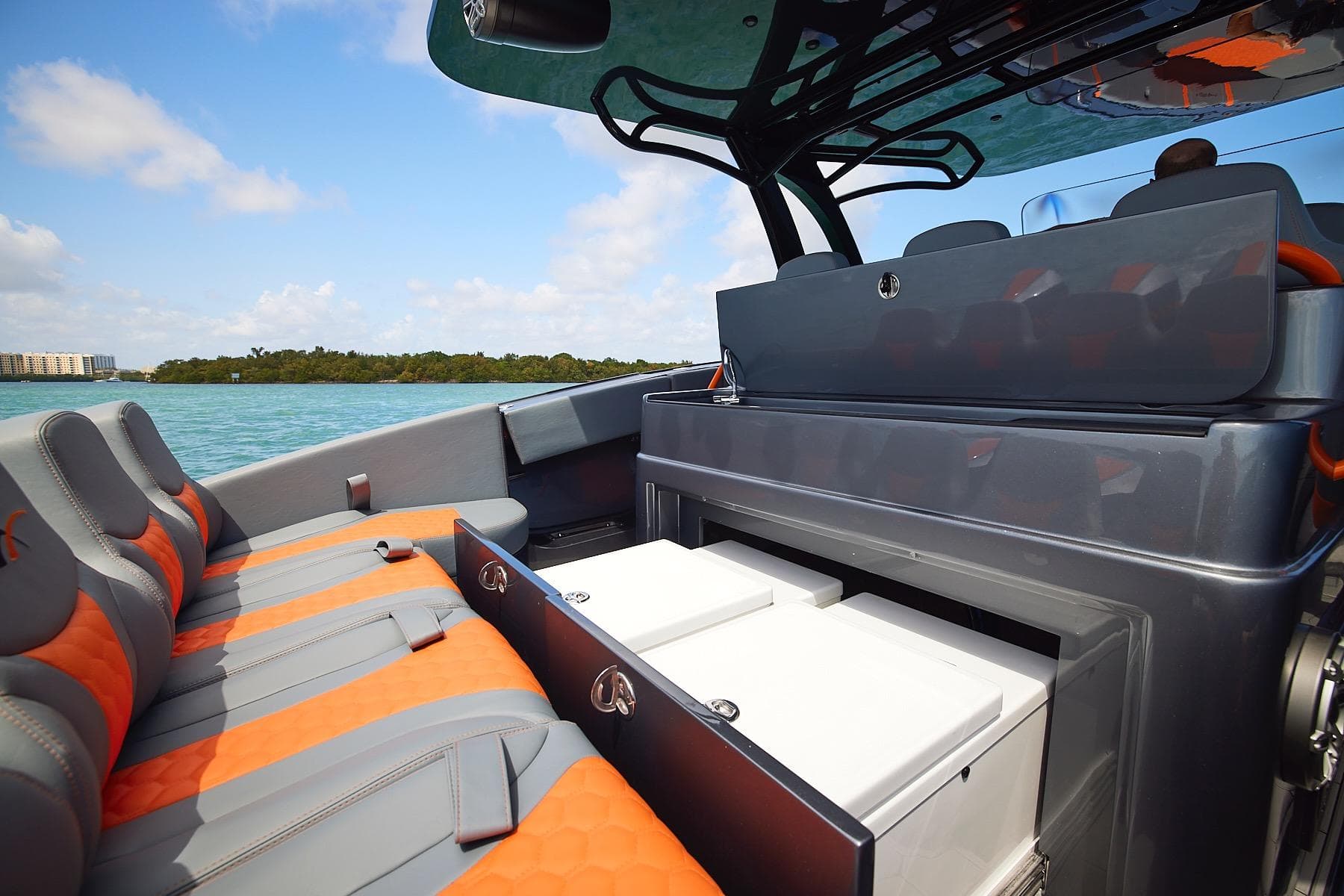 2022 Midnight Express 43 Open boat interior with orange and gray seating, open storage compartments.