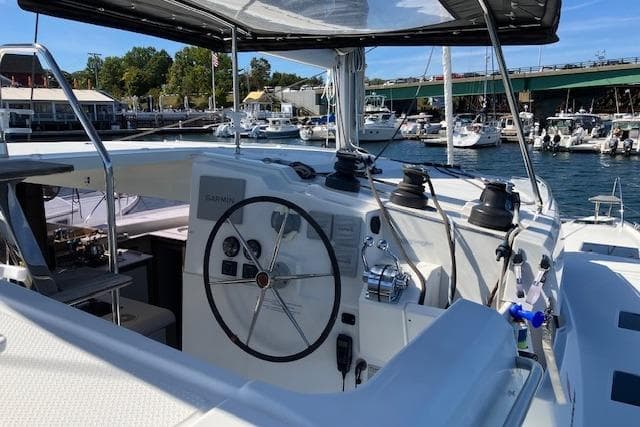 2021 Fountaine Pajot Isla 40 catamaran helm with marina backdrop.