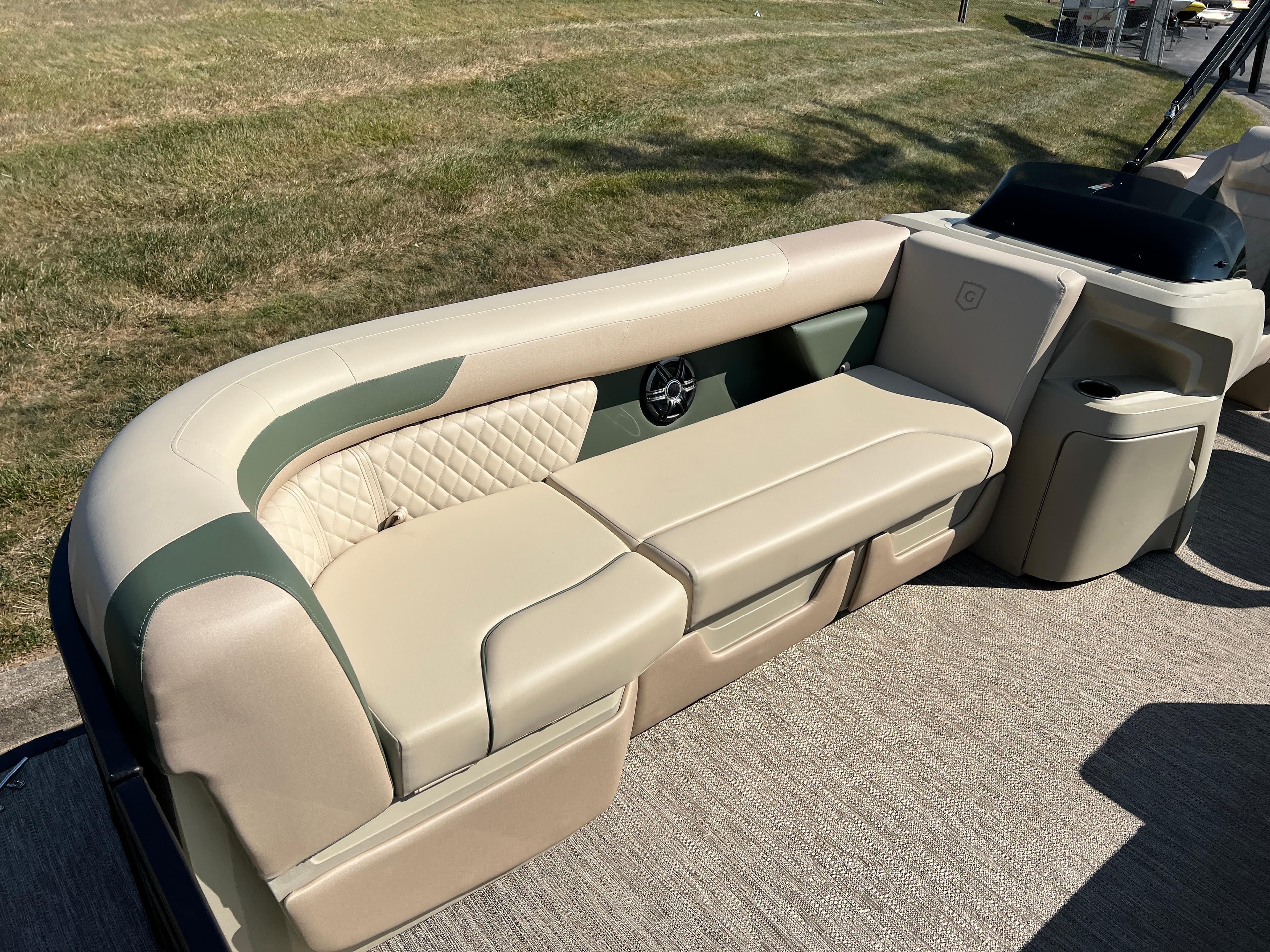 2025 Godfrey SWEETWATER 2286 MT boat interior with beige seating and green accents.