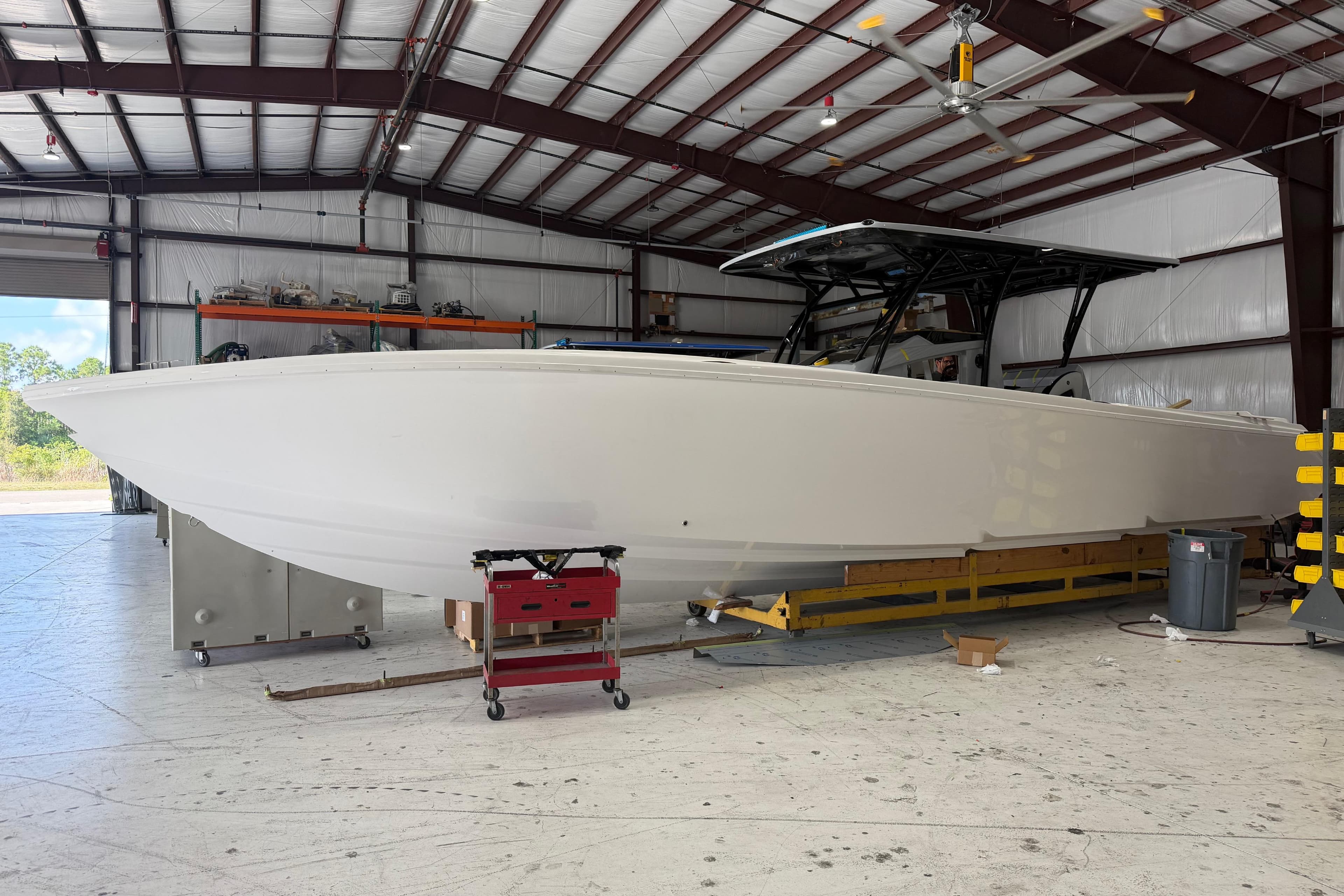 2027 Nor-Tech 390 Sport Center Console boat in a spacious indoor facility.