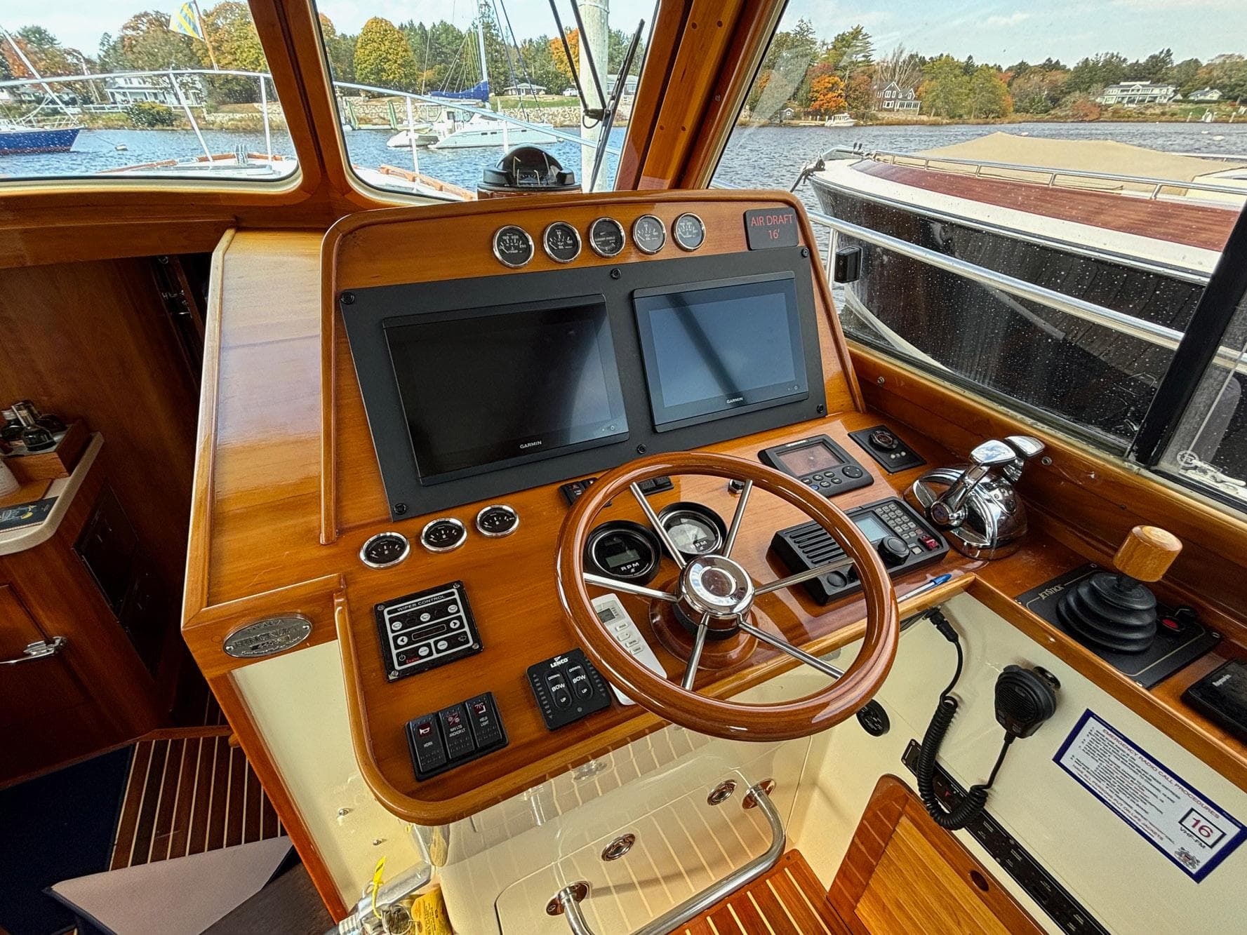 Helm of 2005 Hinckley Talaria 44 MY with wooden dashboard and dual screens.