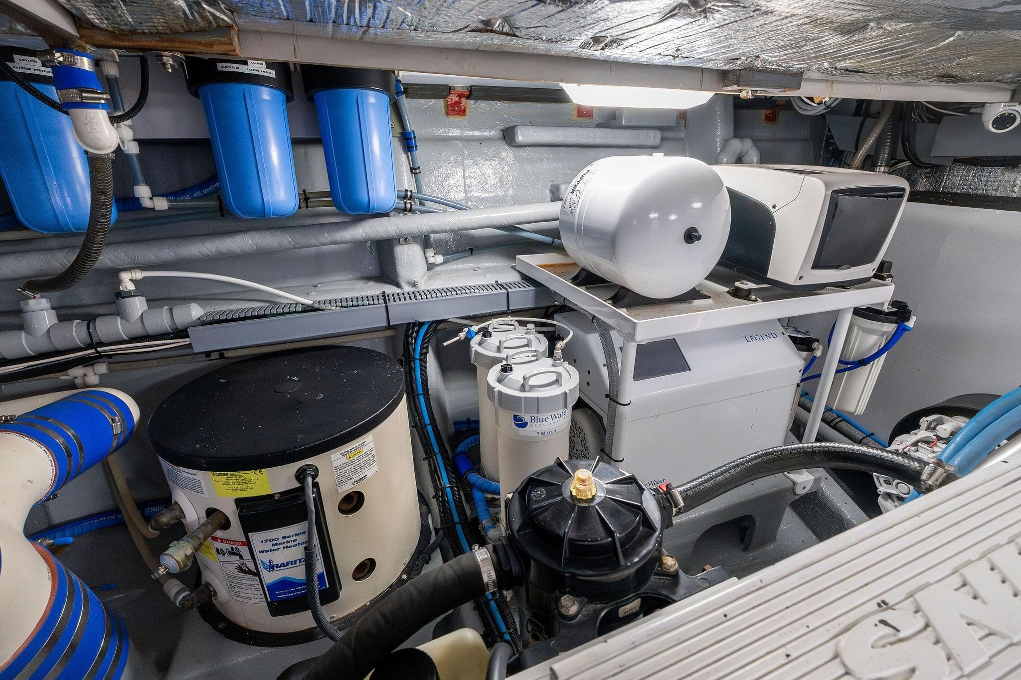 Engine room of a 1995 Itama 46 yacht, featuring filtration and mechanical systems.