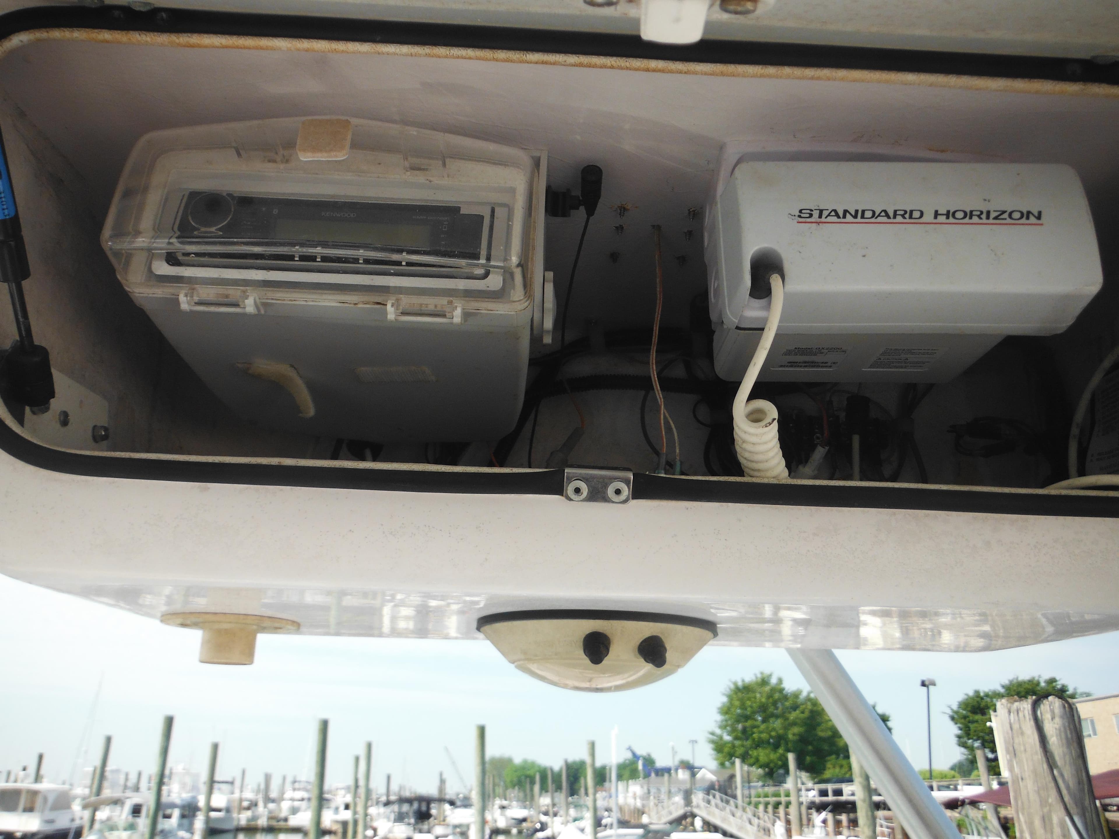 2002 Pro-Line 23 Walk boat electronics compartment with Standard Horizon equipment.