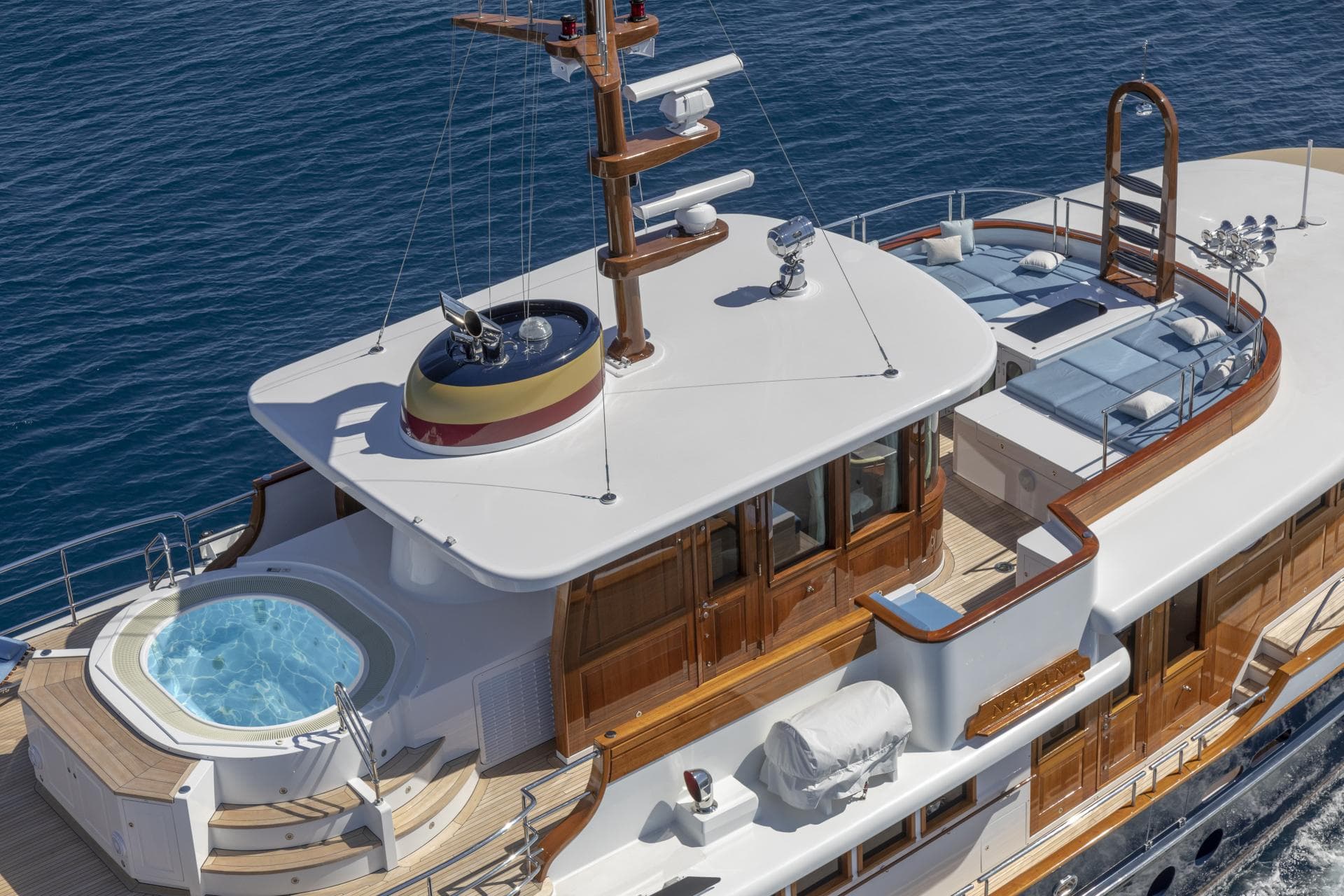 Luxurious 2009 Burger NADAN yacht with jacuzzi and sunbathing area on deck.