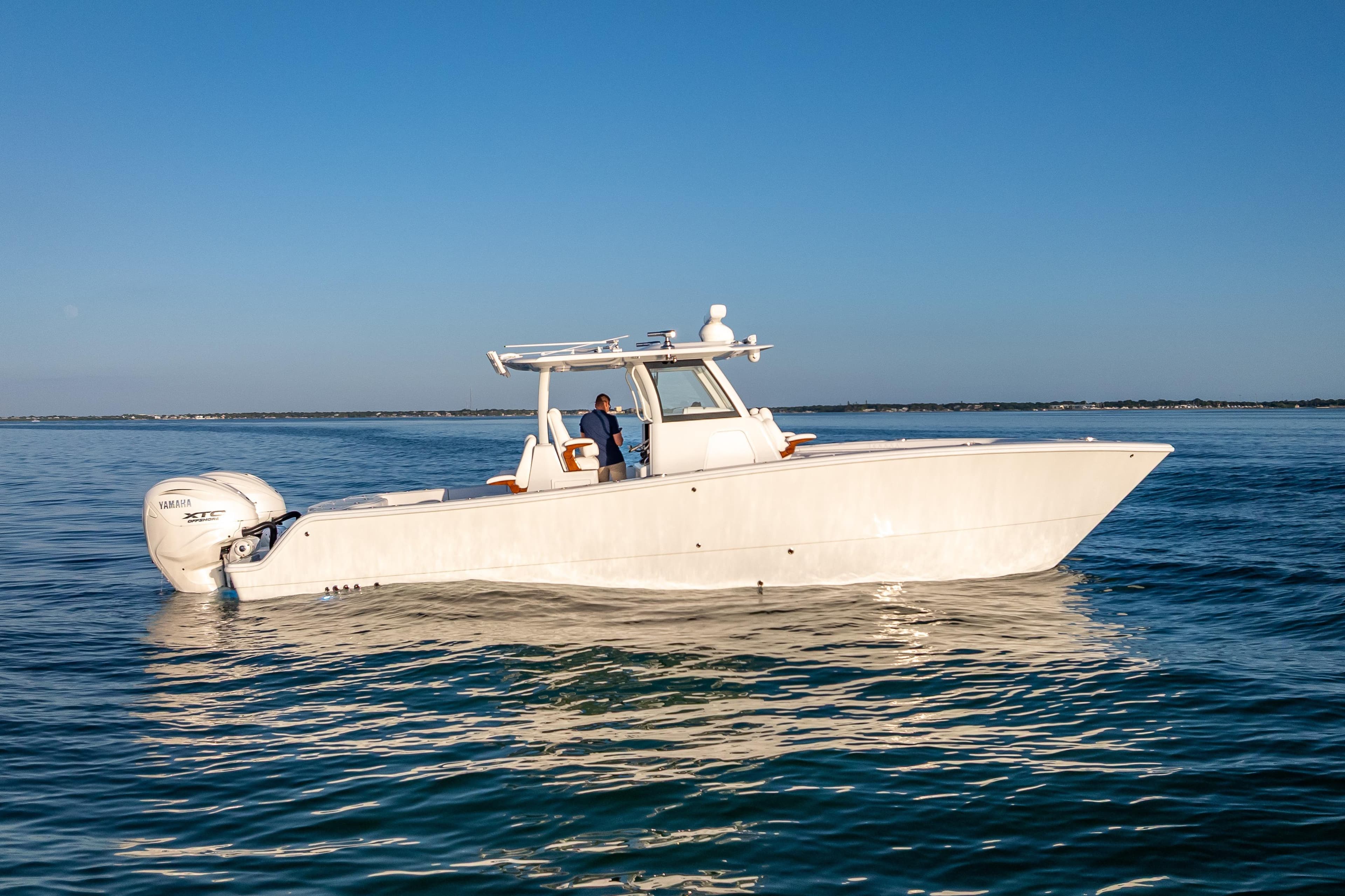 2026 Freeman 35 boat on calm blue water under clear sky.