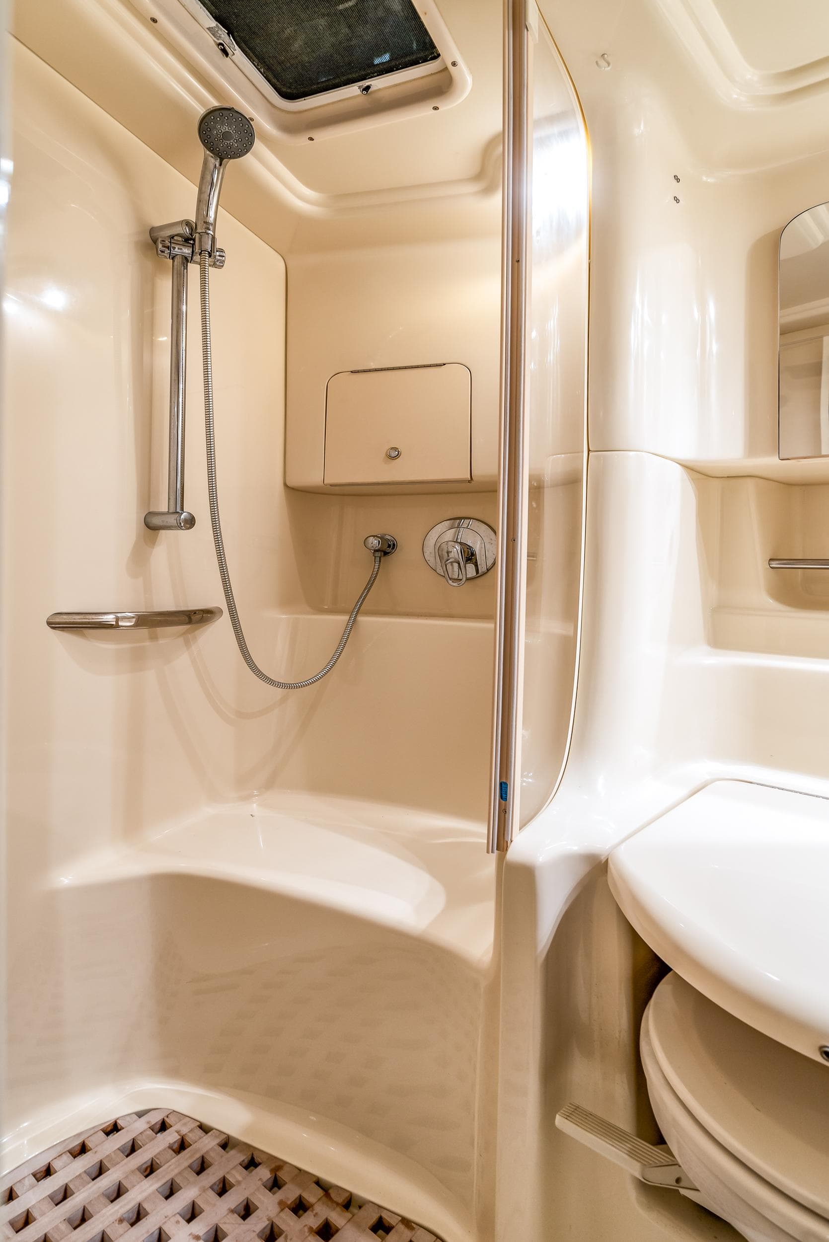 Luxurious bathroom in 2002 Sea Ray 380 Sundancer yacht with shower and modern amenities.