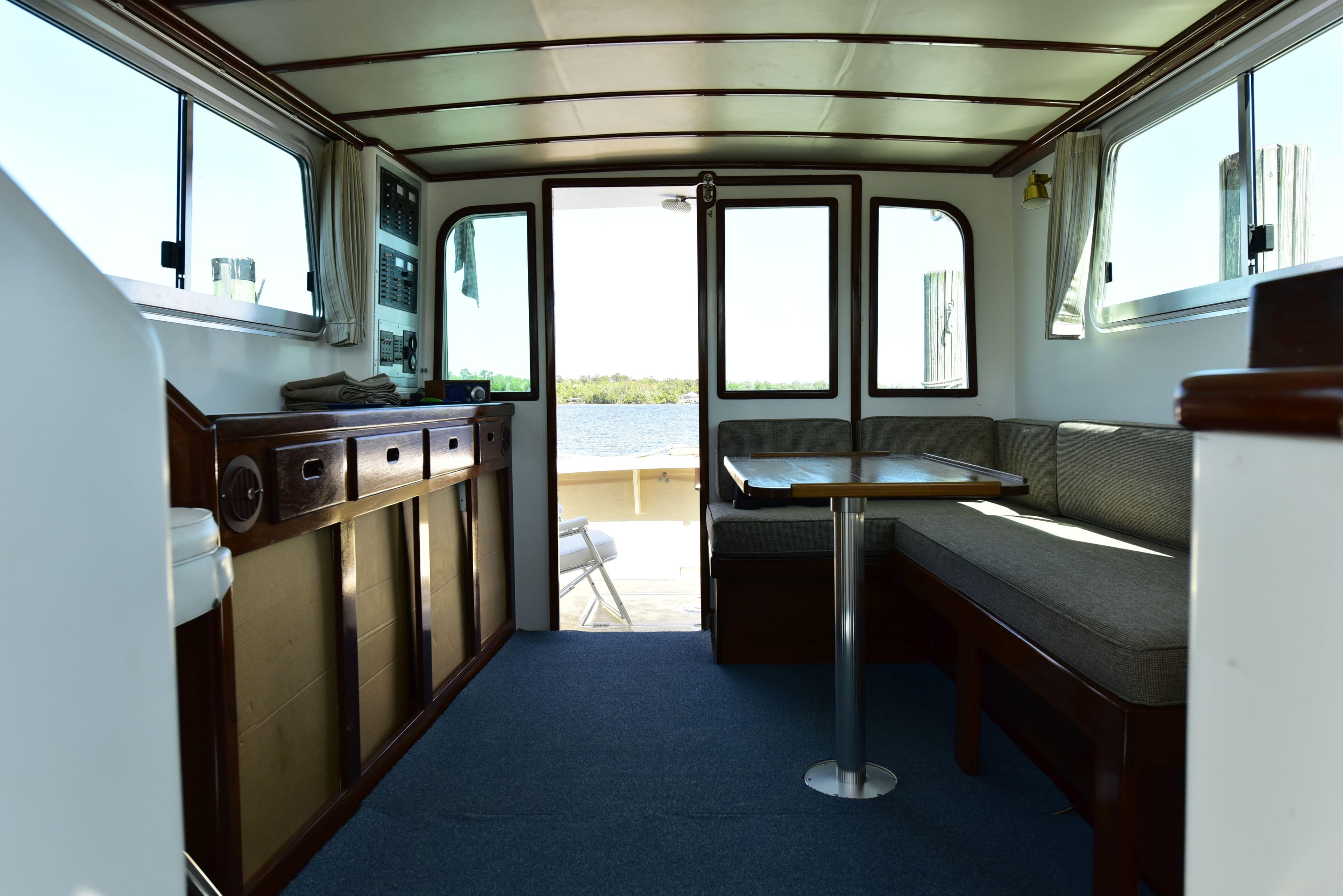 Interior of 1998 Duffy 35 Downeast Cruiser with seating and table, overlooking water.