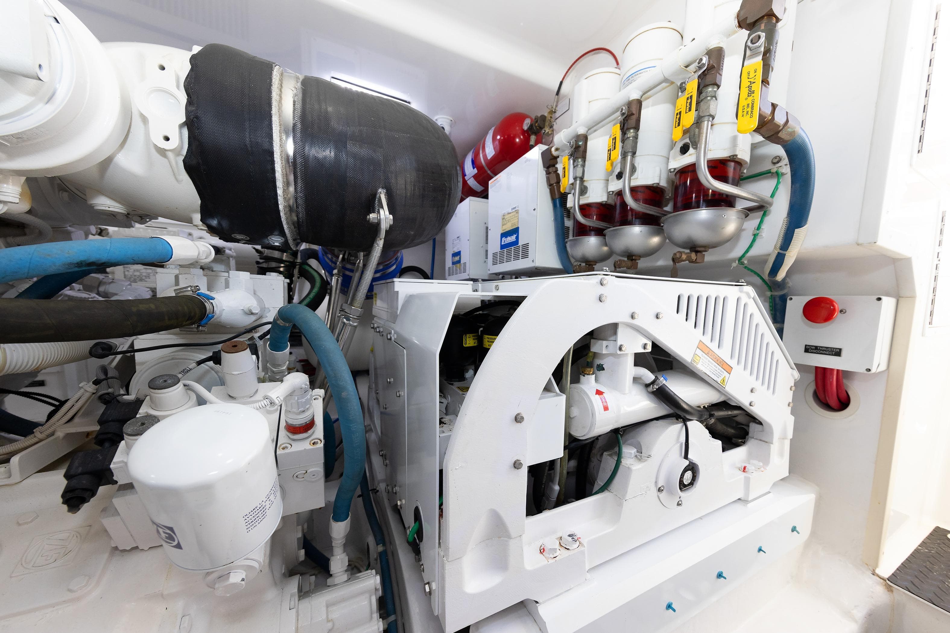 Engine room of 2017 Viking 52 Sport Tower with mechanical components and piping.