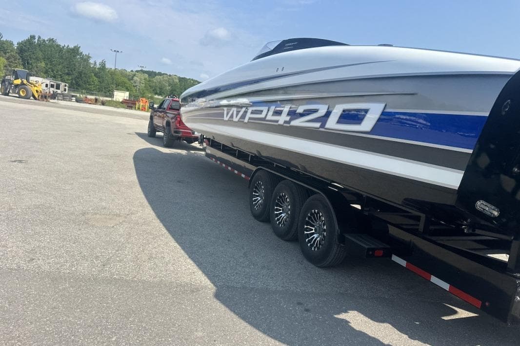 2018 Wright Performance 420 boat on trailer, parked in a lot under a clear sky.