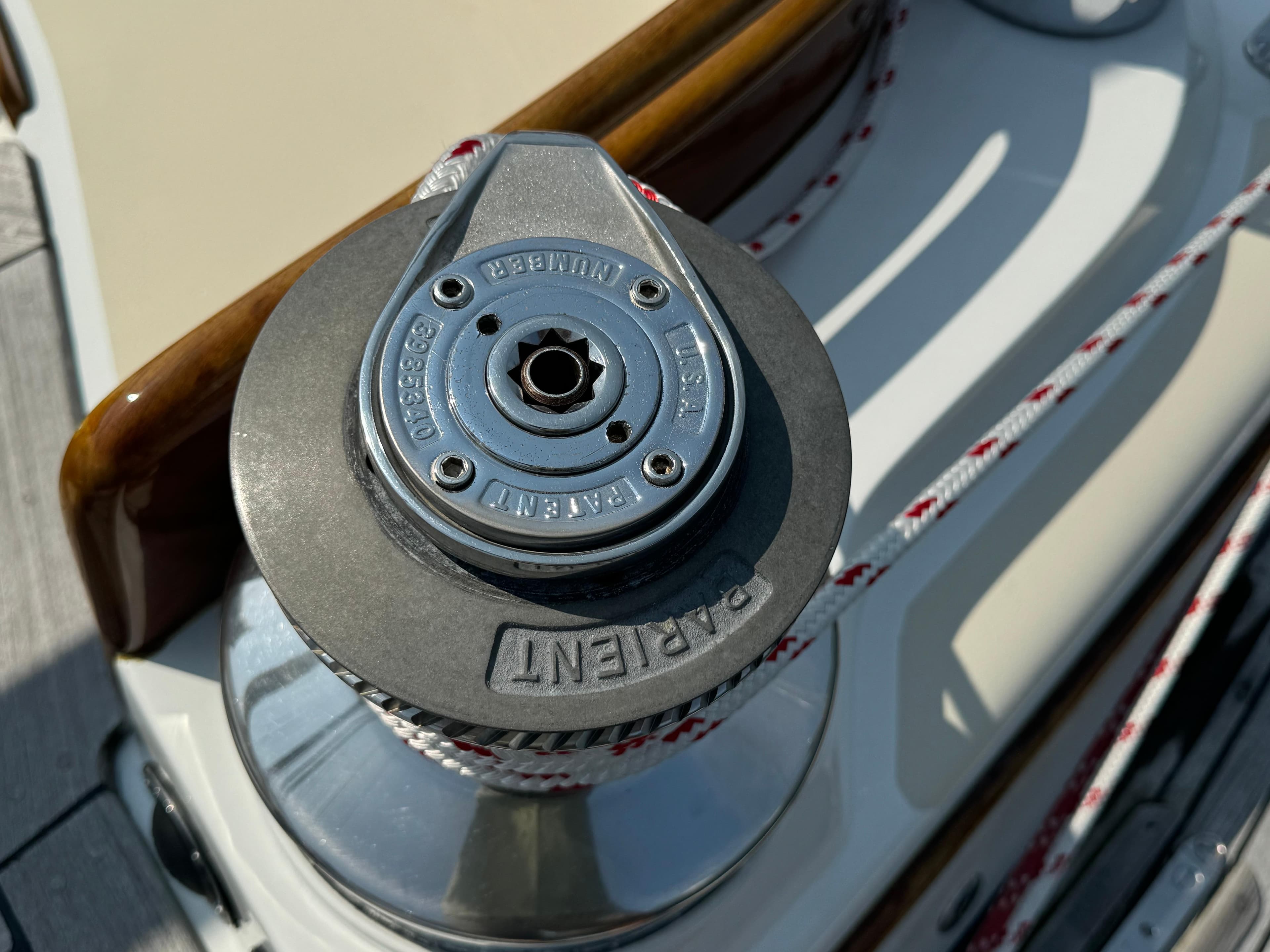 Winch on 1986 Little Harbor 46 Center Cockpit sailboat, featuring Lewmar branding and ropes.
