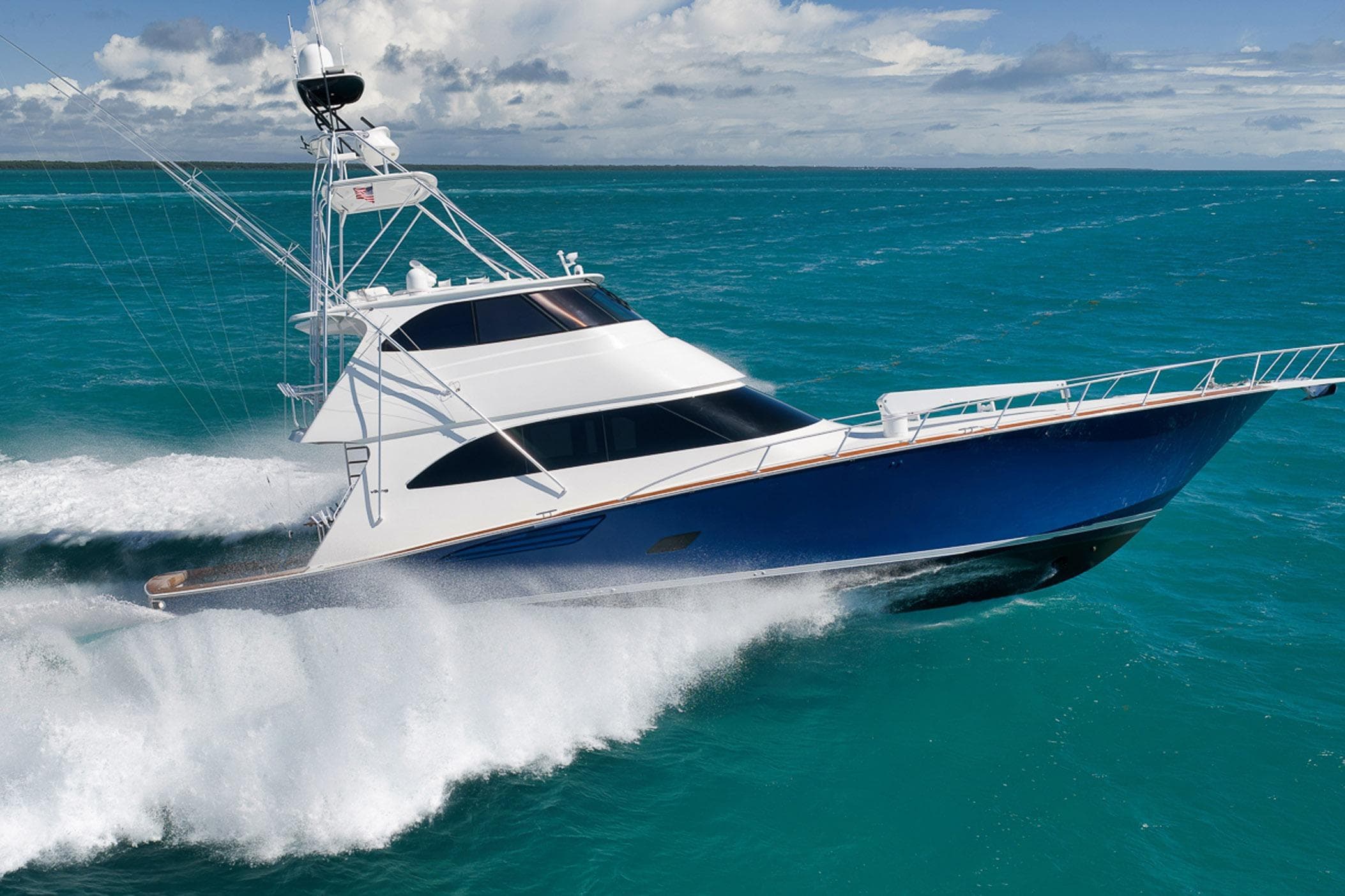 2015 Viking 76 Enclosed Bridge yacht cruising on turquoise ocean waters.
