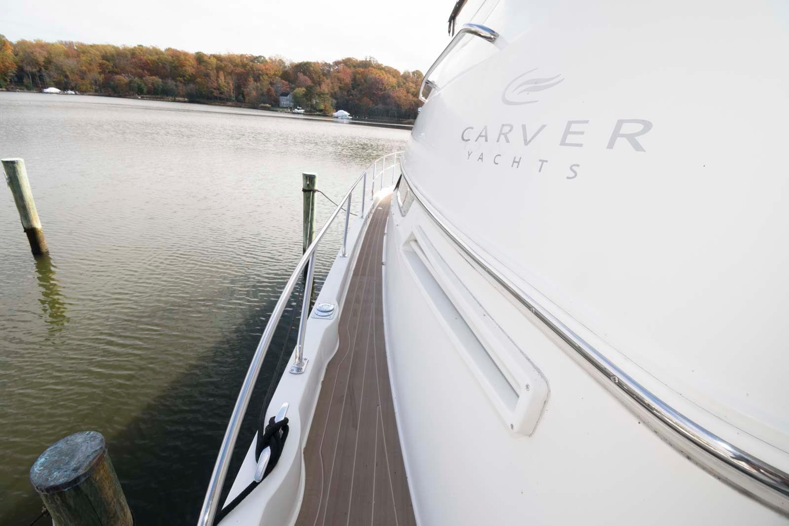 2007 Carver 43 Motor Yacht docked by a serene lake.