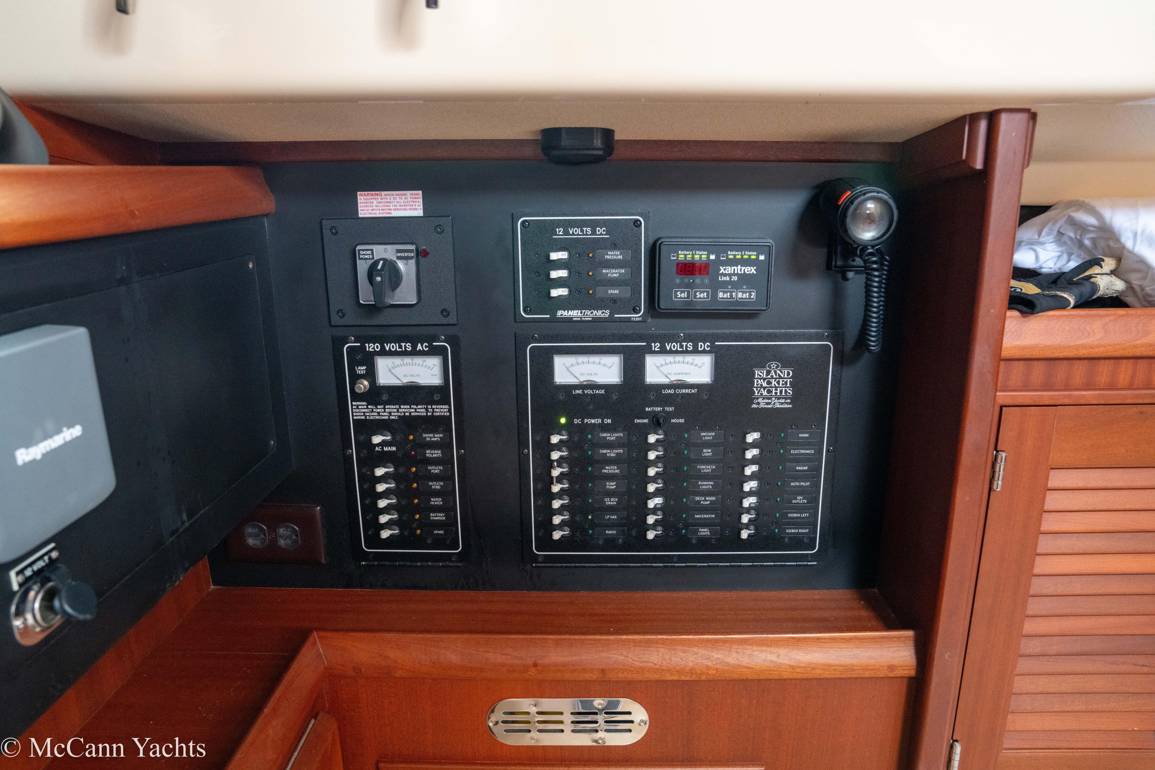 Electrical control panel on a 2010 Island Packet Estero yacht, featuring AC and DC switches.