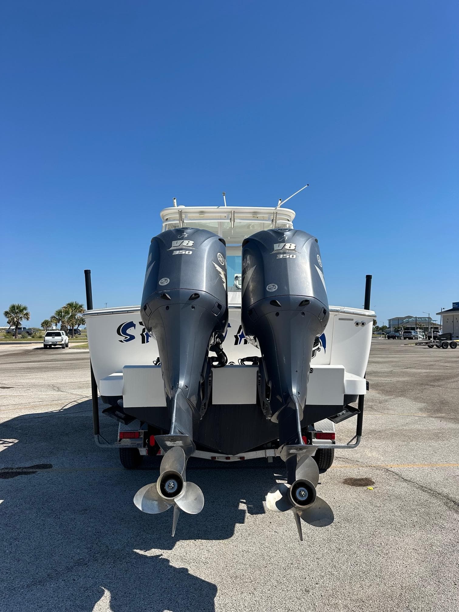 2017 Albemarle Express boat with dual outboard motors, parked on a sunny day.