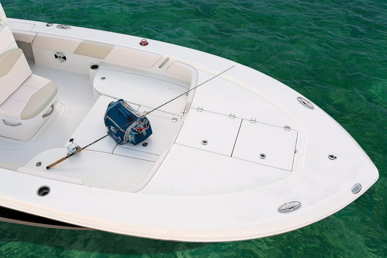Manufacturer Provided Image: 2017 Robalo 246 Cayman boat deck with fishing gear on clear water.