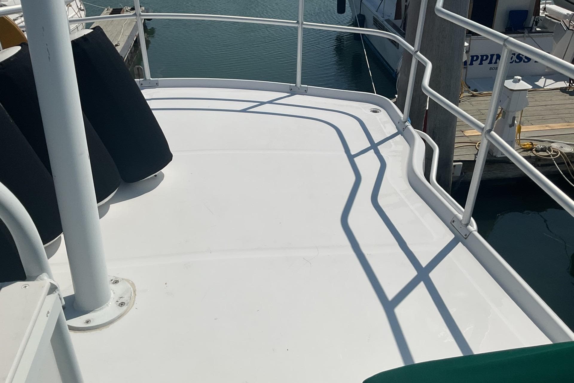 1999 Mainship 350 Trawler deck with railings, docked at marina.