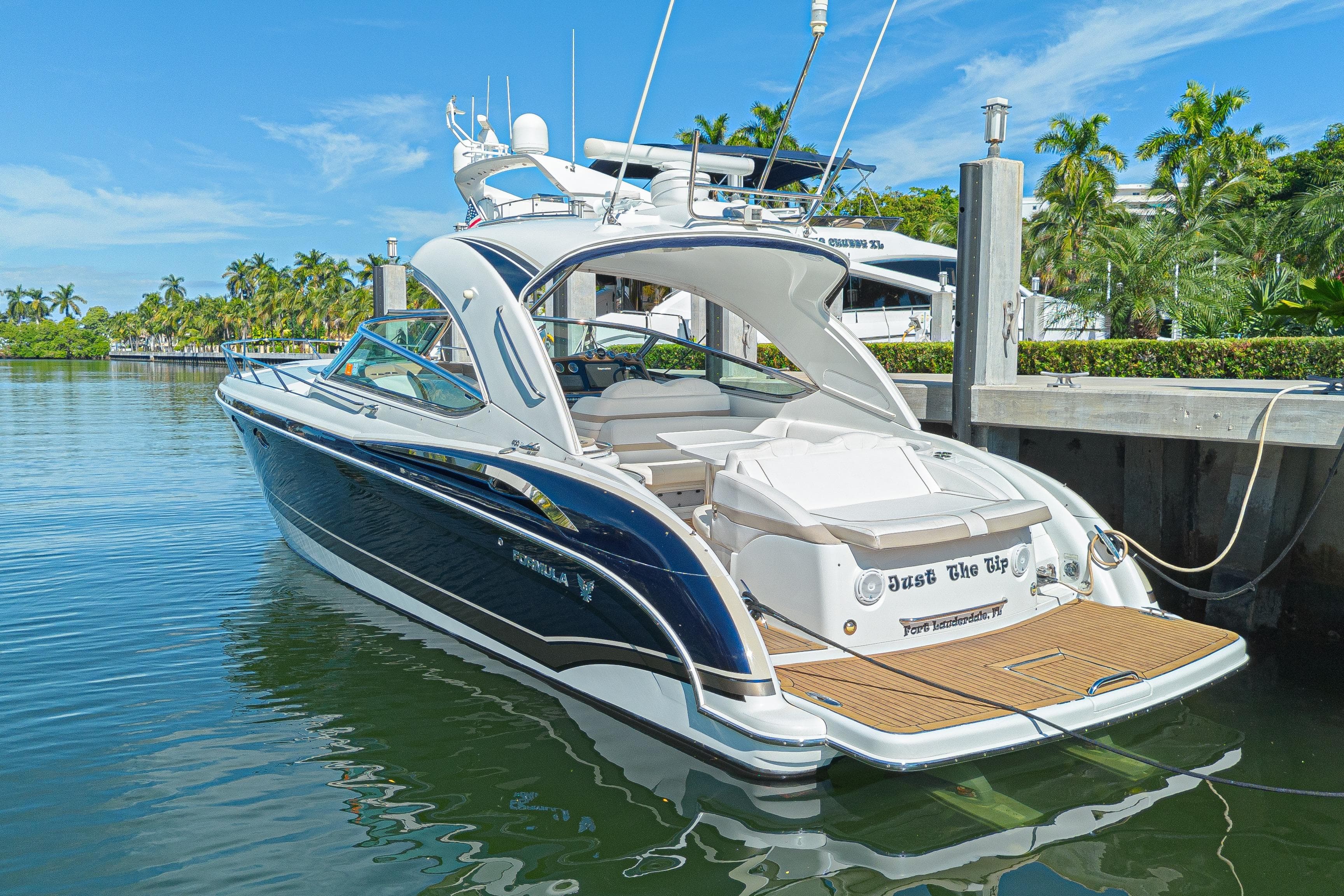 2013 Formula 400 Super Sport yacht docked in sunny marina setting.