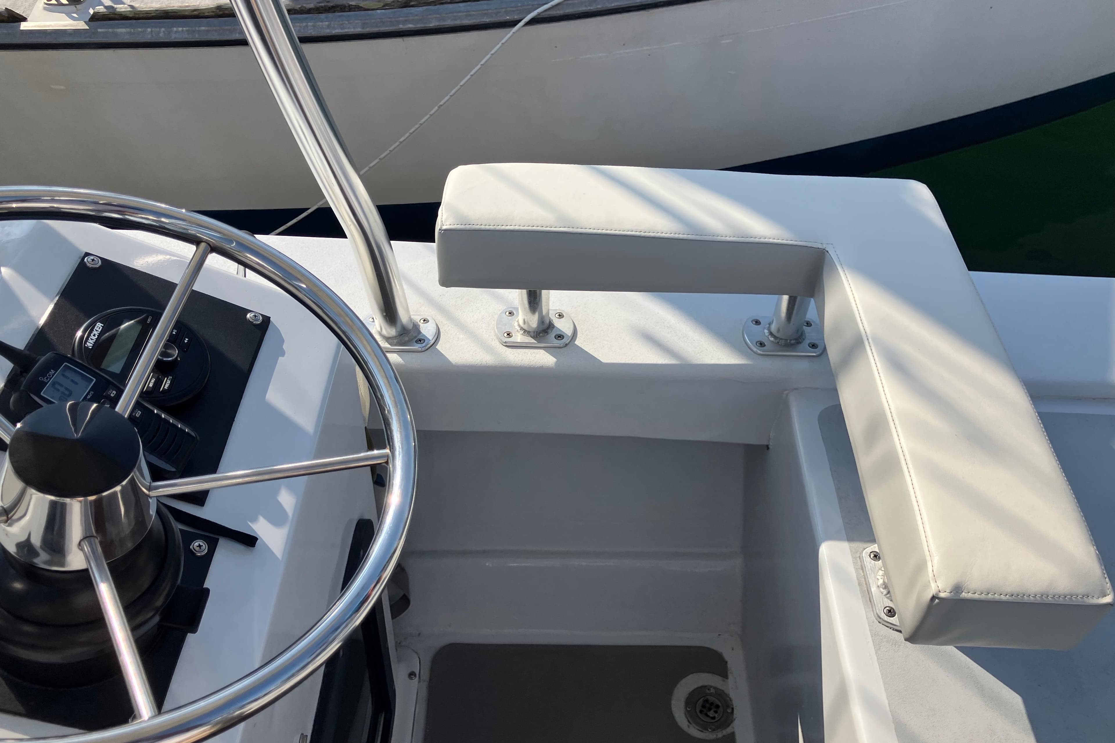 Steering wheel and seating area of a 1996 Premium 28 Parasail boat.