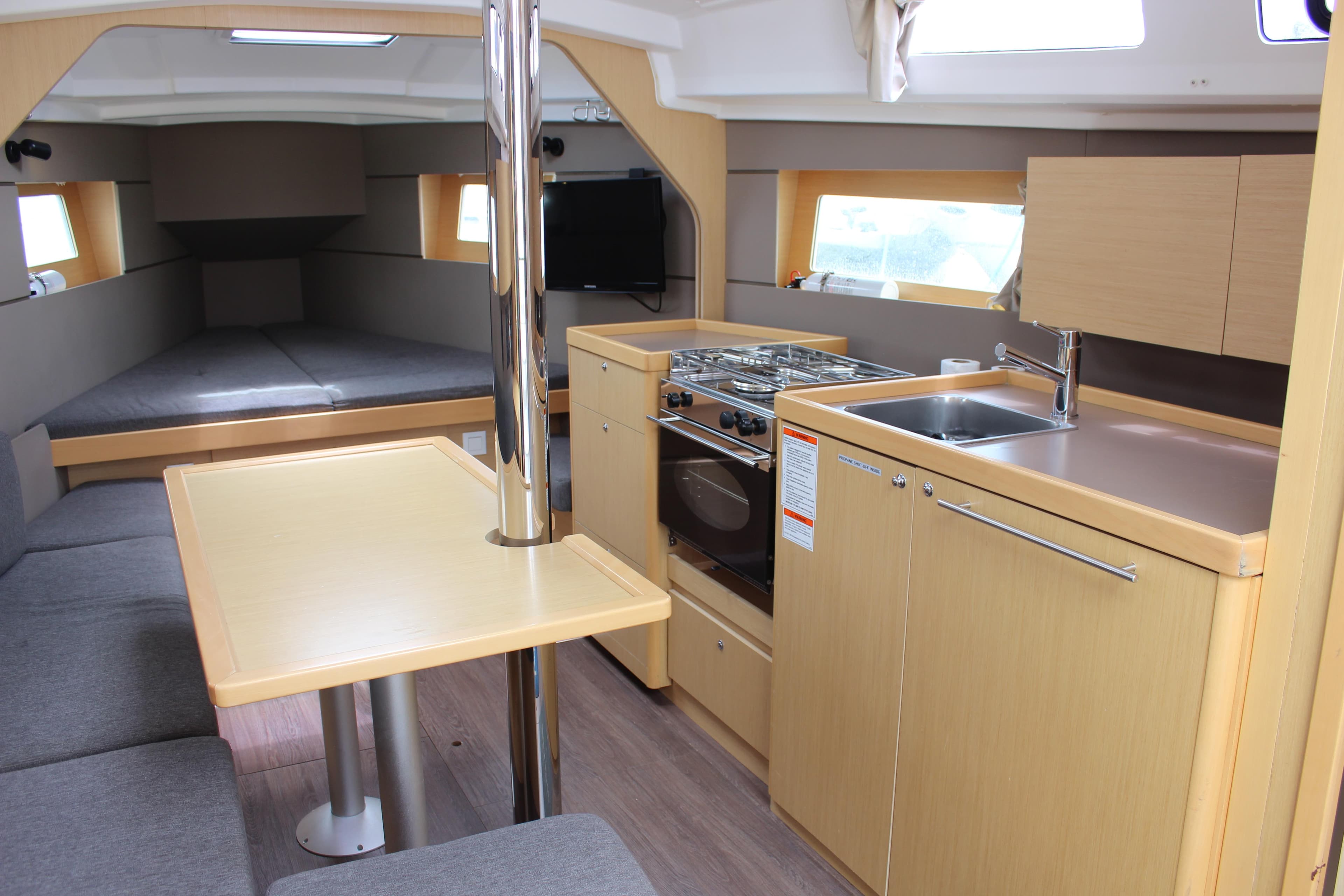 Interior of 2015 Beneteau Oceanis 35 yacht with modern kitchen and dining area.