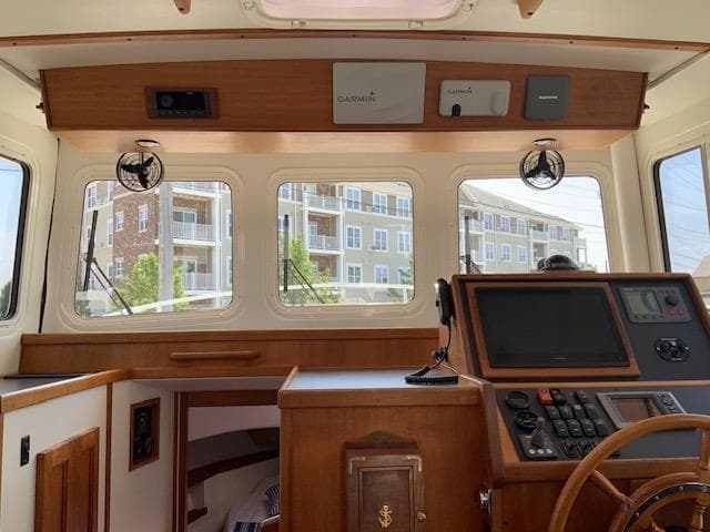 Interior view of a 2010 Nordic Tug 32 boat cockpit with navigation equipment.