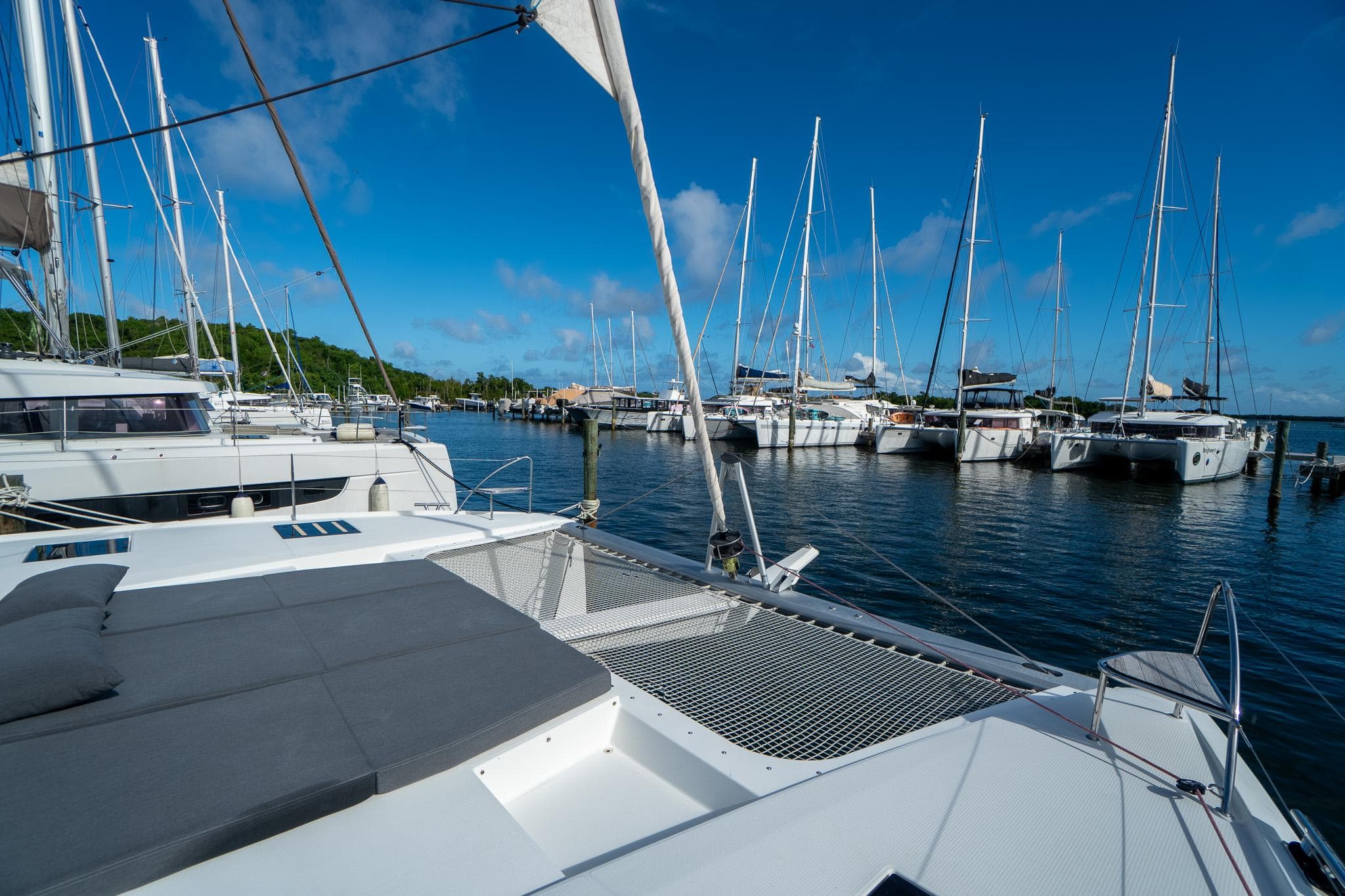 2020 Fountaine Pajot Saona 47 catamaran docked in a marina with clear blue skies.