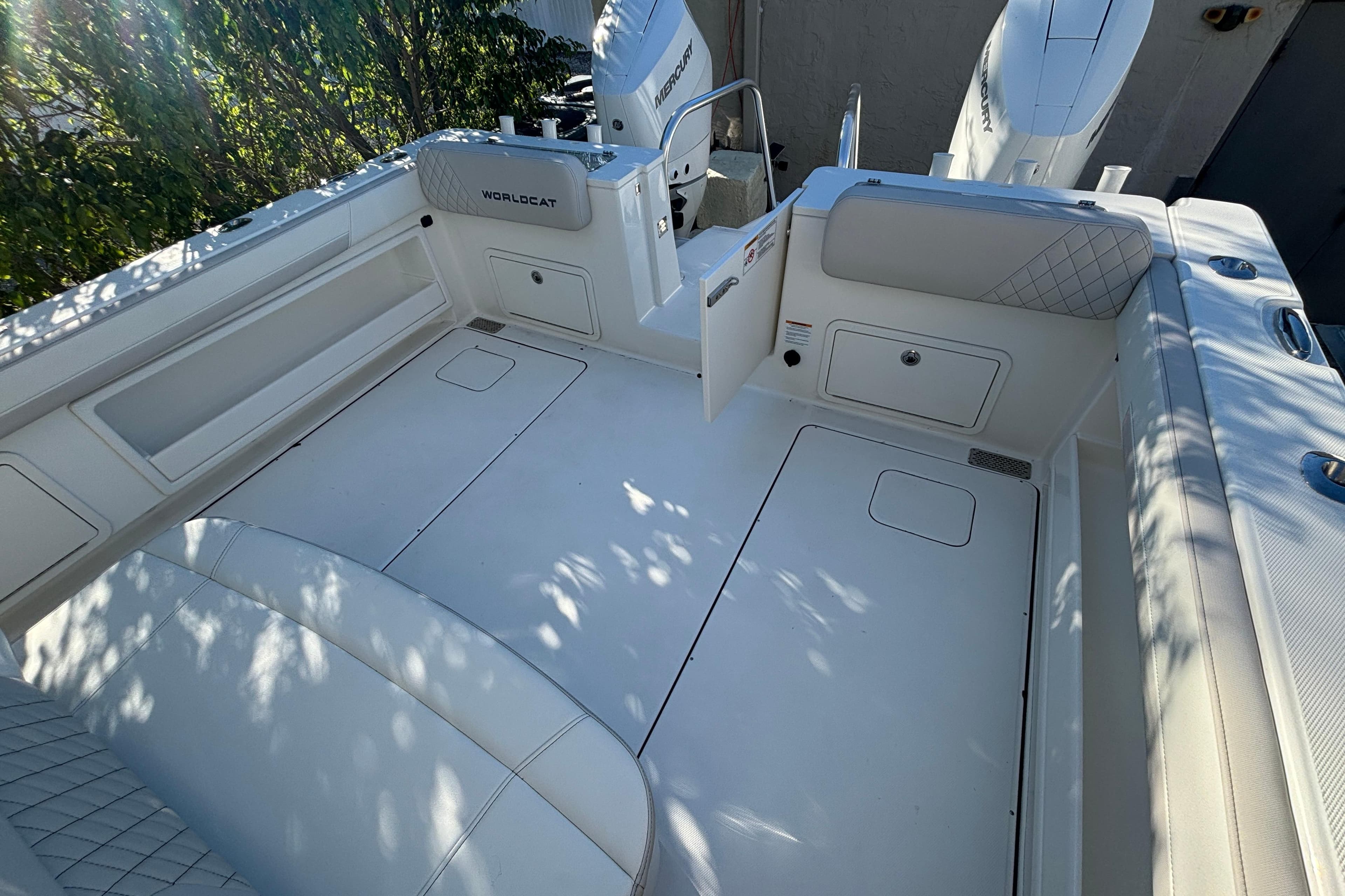 2025 World Cat 325 CC boat interior with white seating and storage compartments.