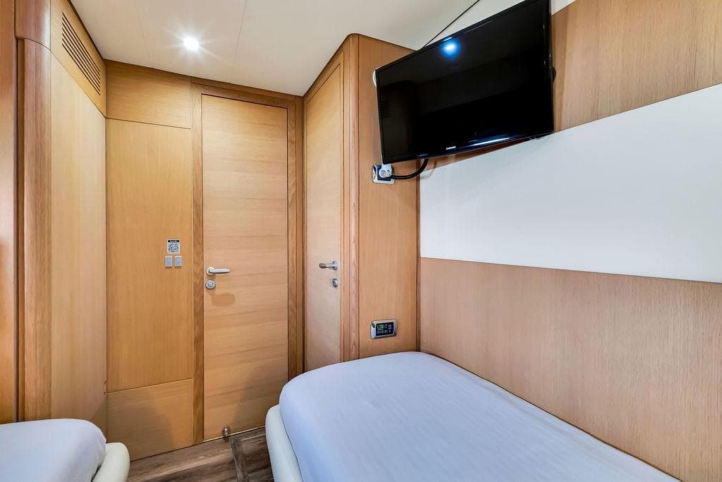 Interior of 2008 Aicon 75 yacht cabin with twin beds and wall-mounted TV.