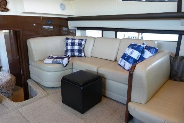 Luxurious interior of 2009 Carver 41 Cockpit Motor Yacht with beige seating and nautical decor.