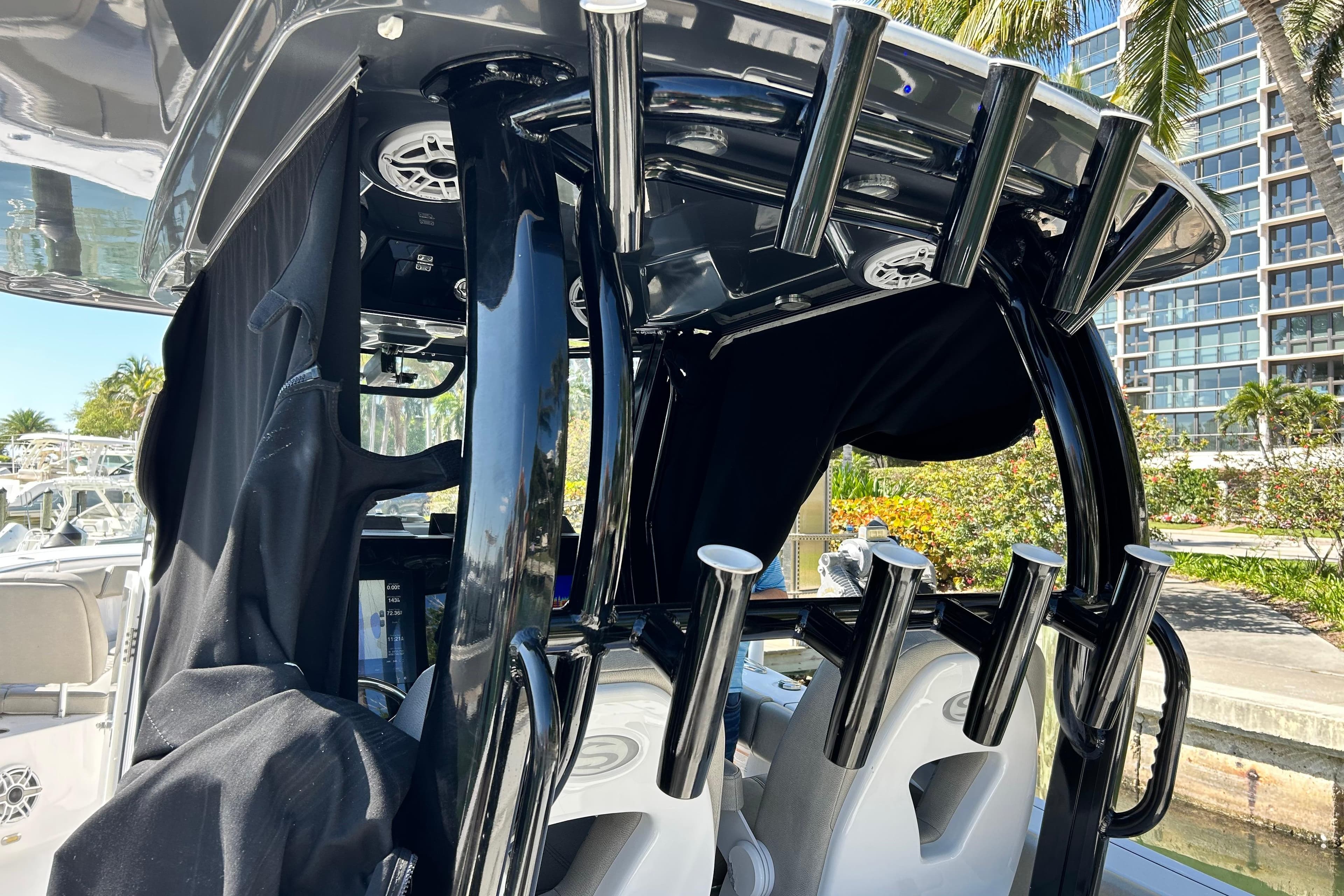2021 Sportsman Open 302 Center Console boat interior with rod holders and speakers.