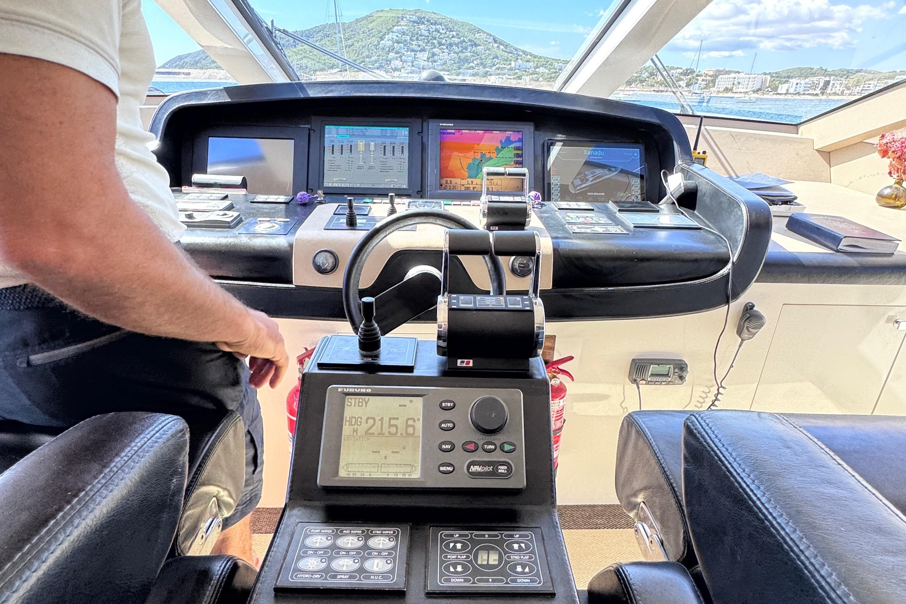Cockpit of 2010 Canados 90 yacht with navigation equipment and scenic view.
