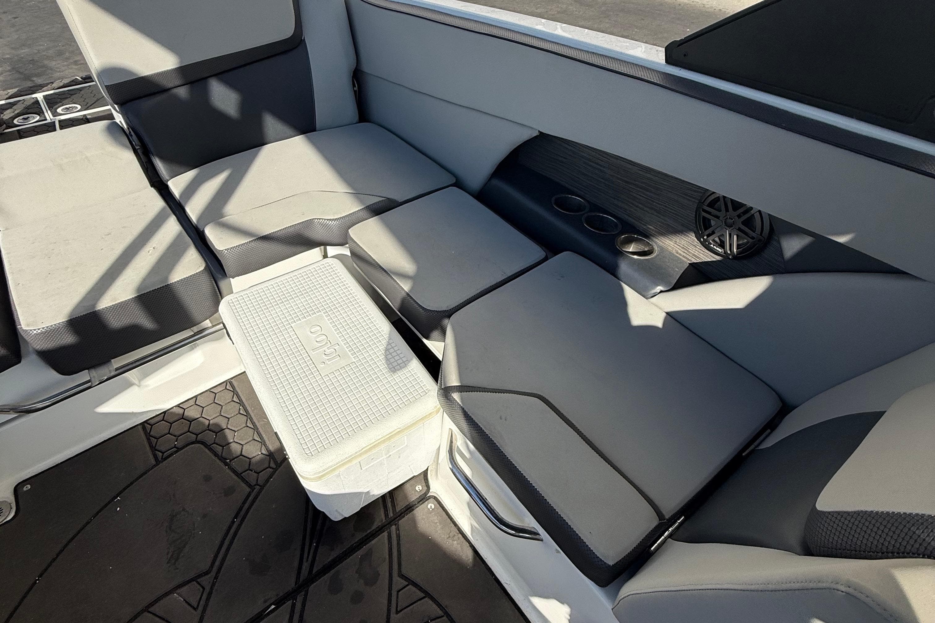 Interior seating of 2021 Scarab 255 ID boat with cooler and cup holders.