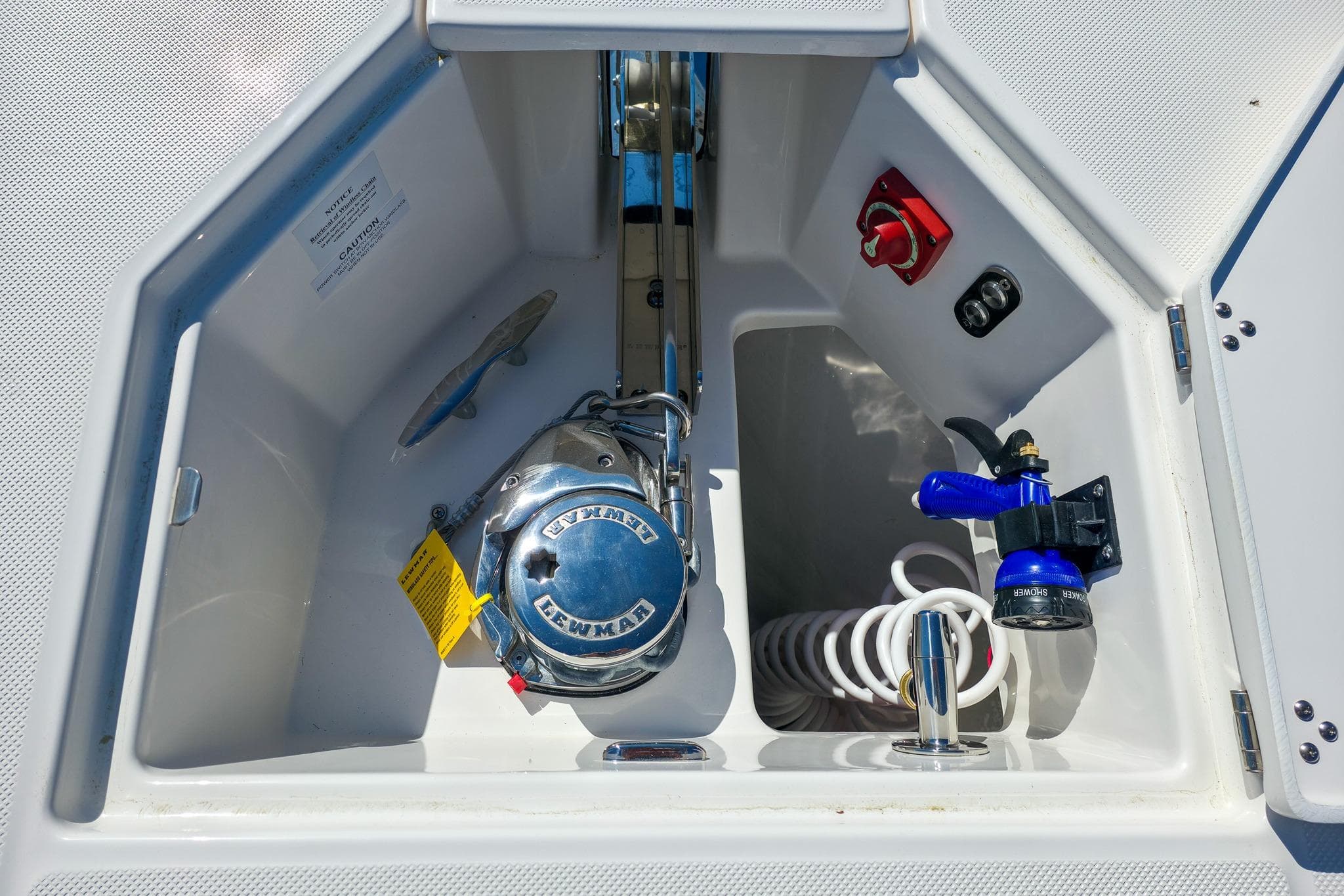 Anchor compartment of 2026 Regal 38 SAV boat with Lewmar windlass and hose.