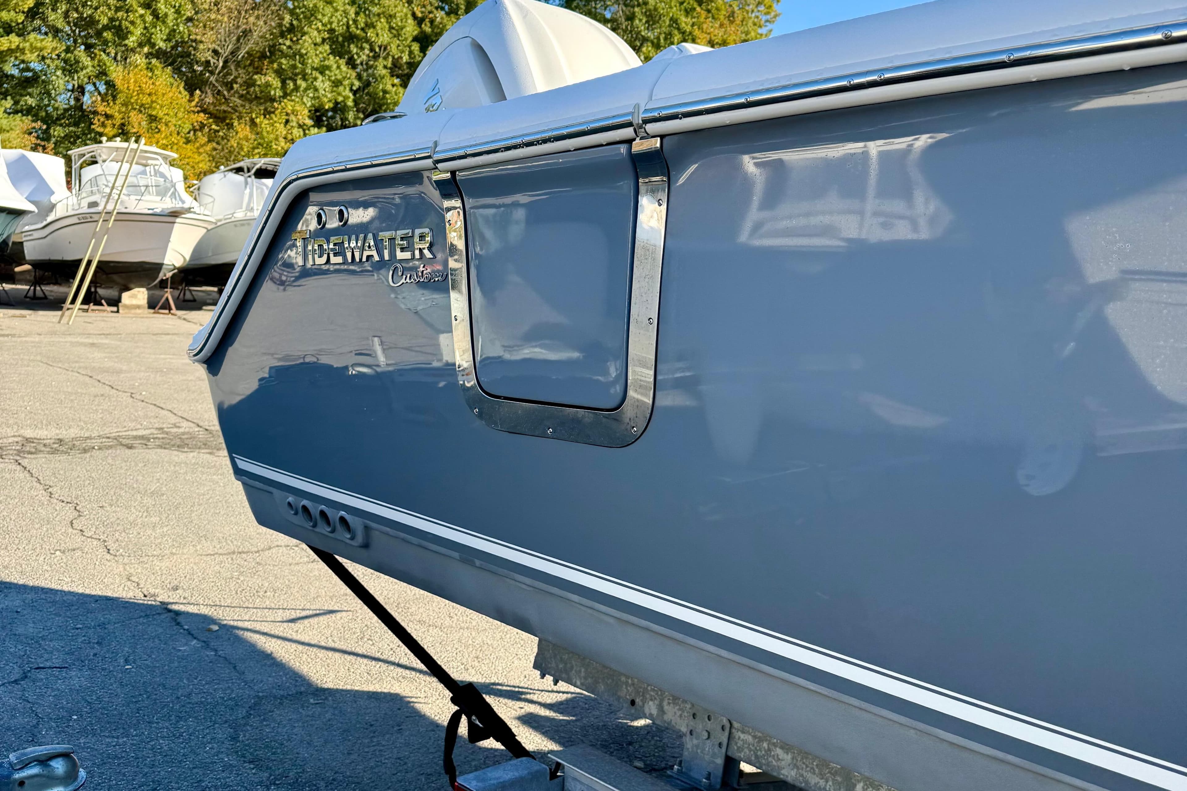 2026 Tidewater 282 CC Adventure boat in a marina, side view.