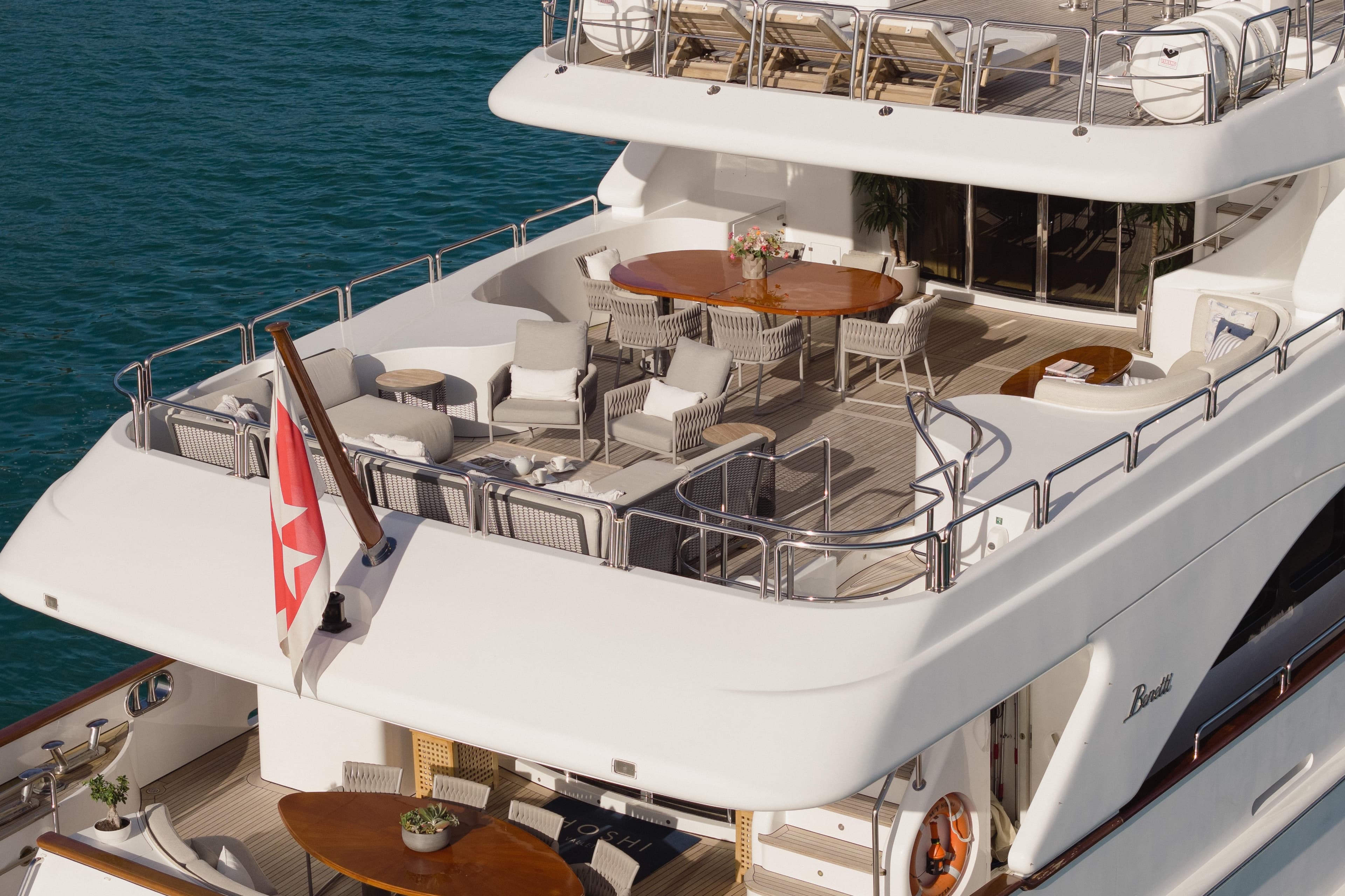 Luxurious 2000 Benetti Classic 115 yacht with elegant outdoor seating and dining area.