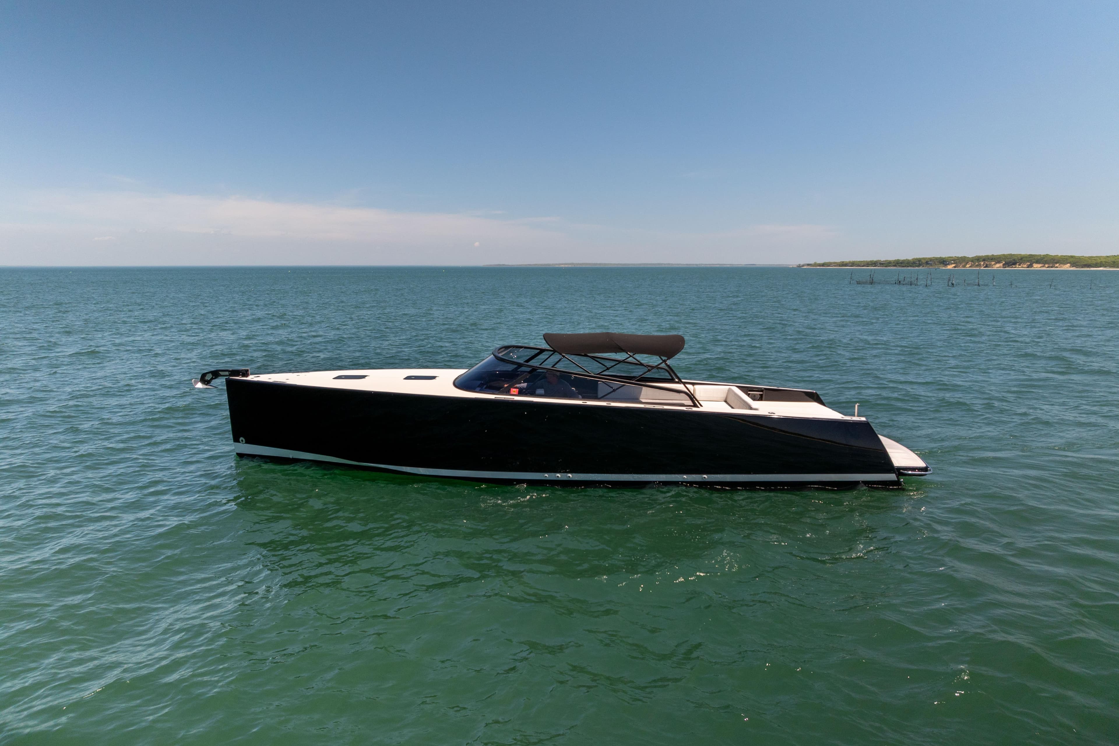 2016 VanDutch 40 yacht on open water under clear blue sky.