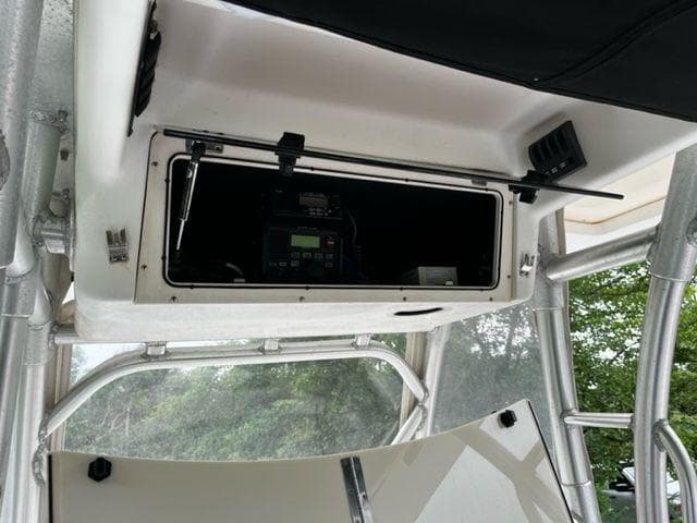 2004 Boston Whaler 320 Outrage electronics compartment with open storage hatch.