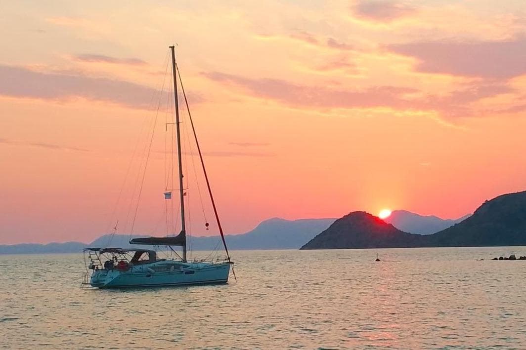 Jeanneau Sun Odyssey 45 DS sailboat at sunset, 2008 model, serene ocean view.