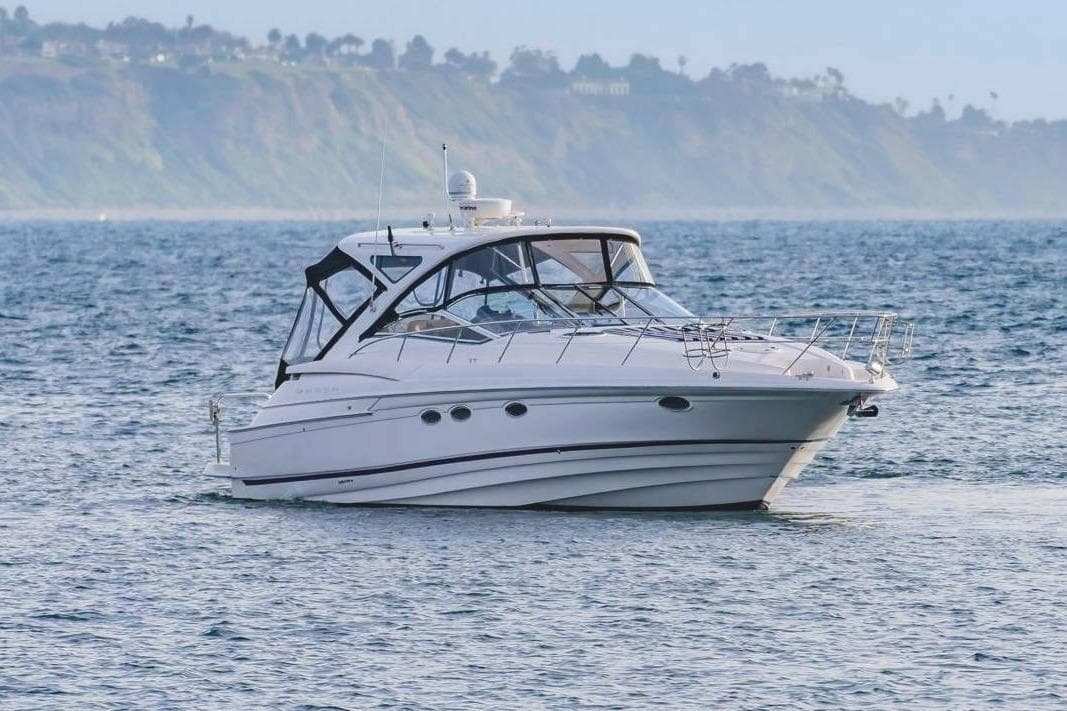 2010 Regal Commodore 4460 yacht cruising on calm ocean waters.