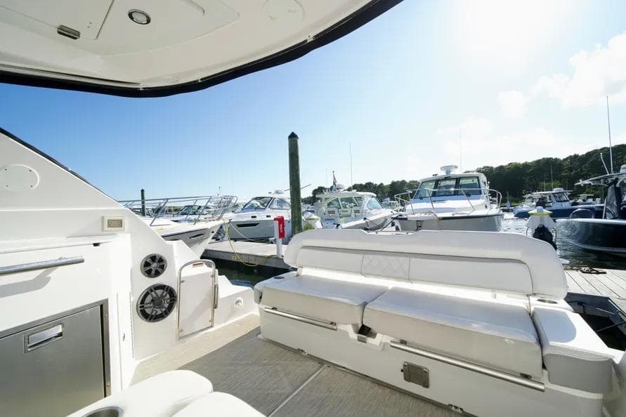 2019 Regal 35 Sport Coupe interior with marina view, featuring white seating and modern amenities.