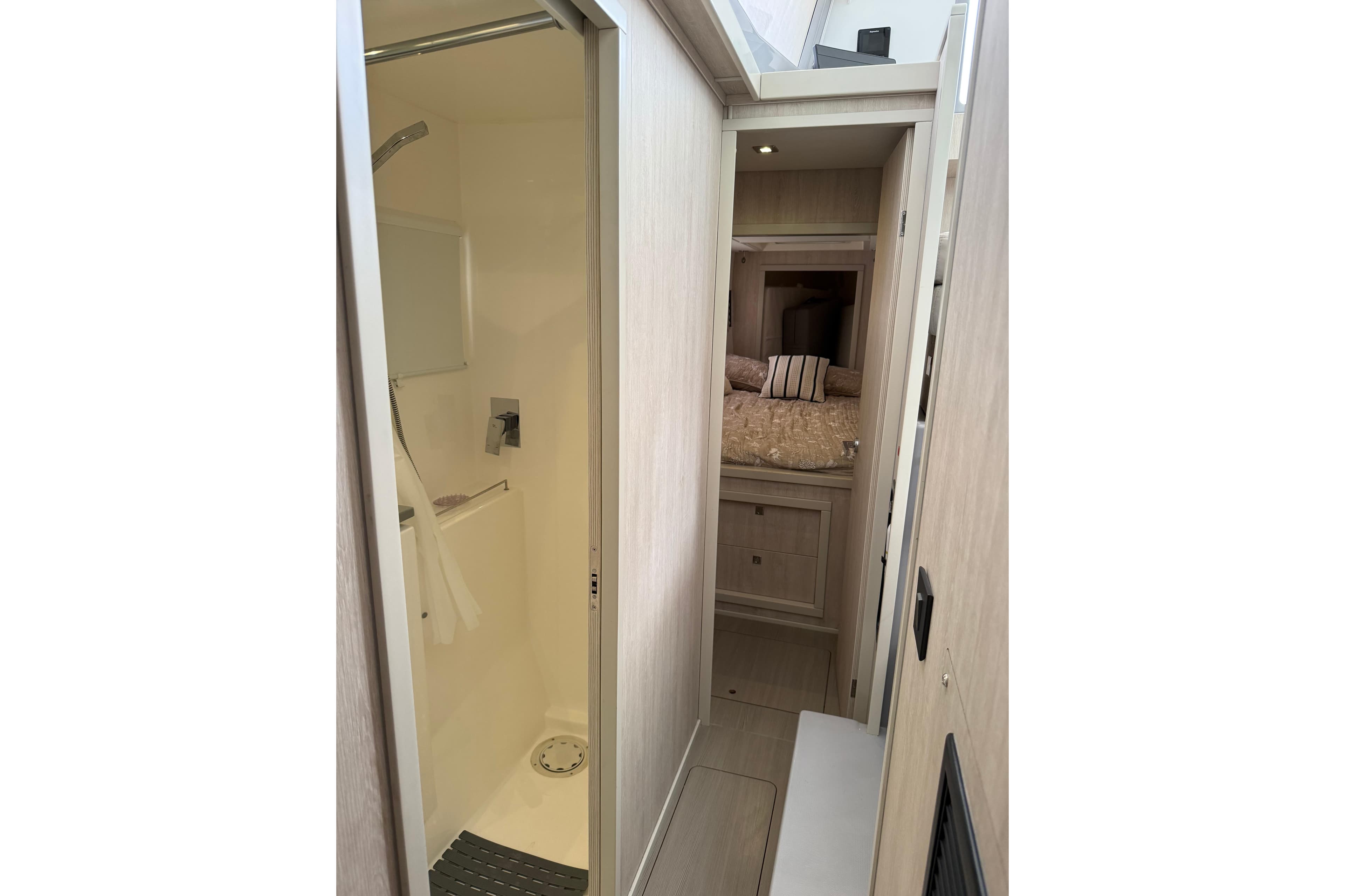 Interior of 2021 Leopard 43 Powercat showing shower and cozy bedroom.
