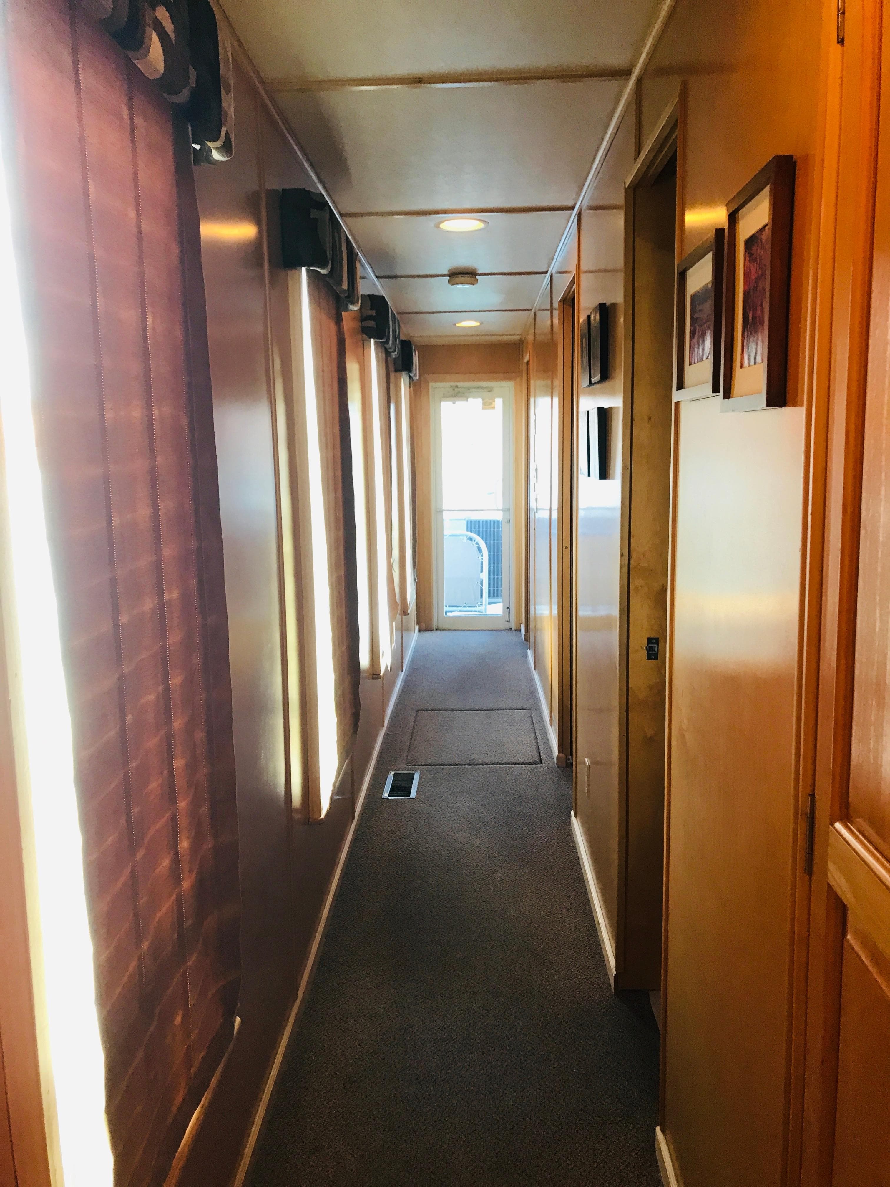 Hallway inside 2005 Stardust Cruisers Summer Obsession Share #37, featuring wood paneling and carpet.